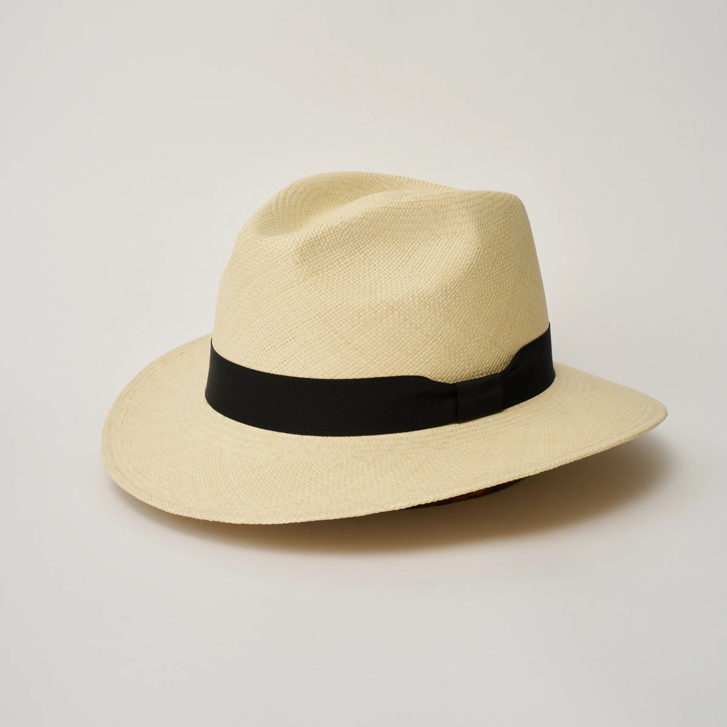 Studio image, angled view of the Camilo City Executive Natural coloured Panama Hat with Black trim, showing the overall hat shape.