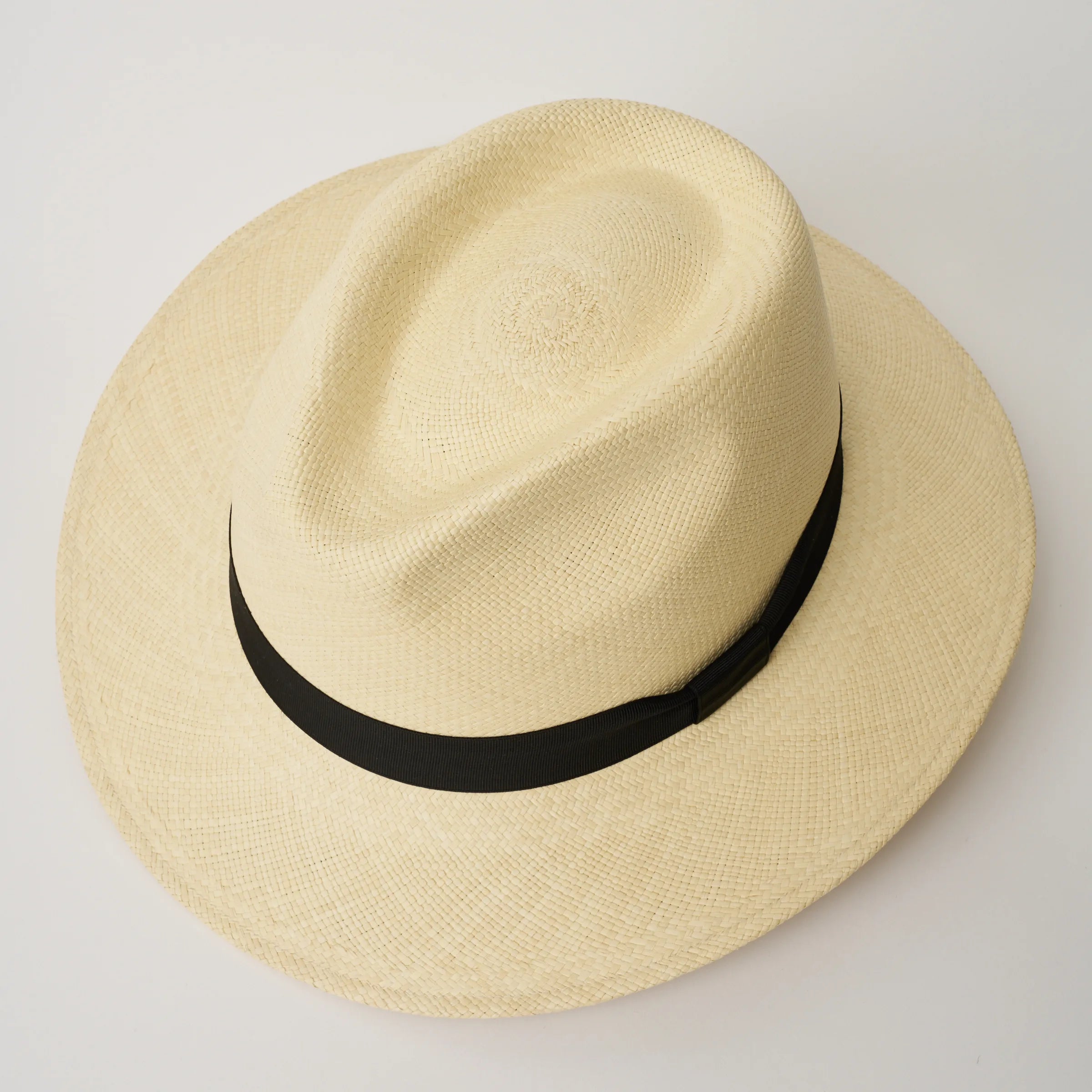 Studio image, taken looking down at the City Executive Natural coloured Panama Hat with Black trim, showing the crown shape and pinch.