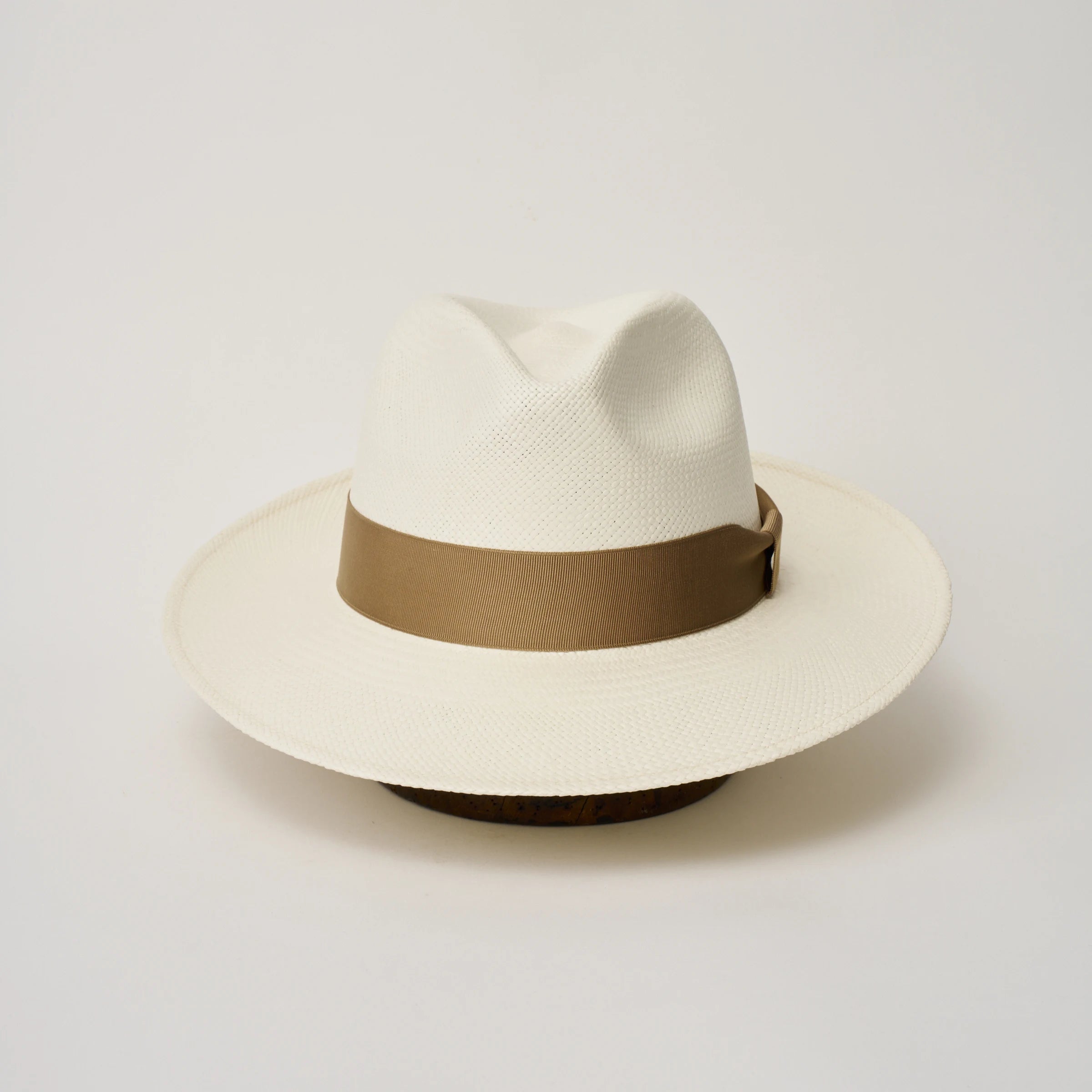 Studio image of the Camilo Classic Cream coloured Panama Hat with Tan trim shown from the front.