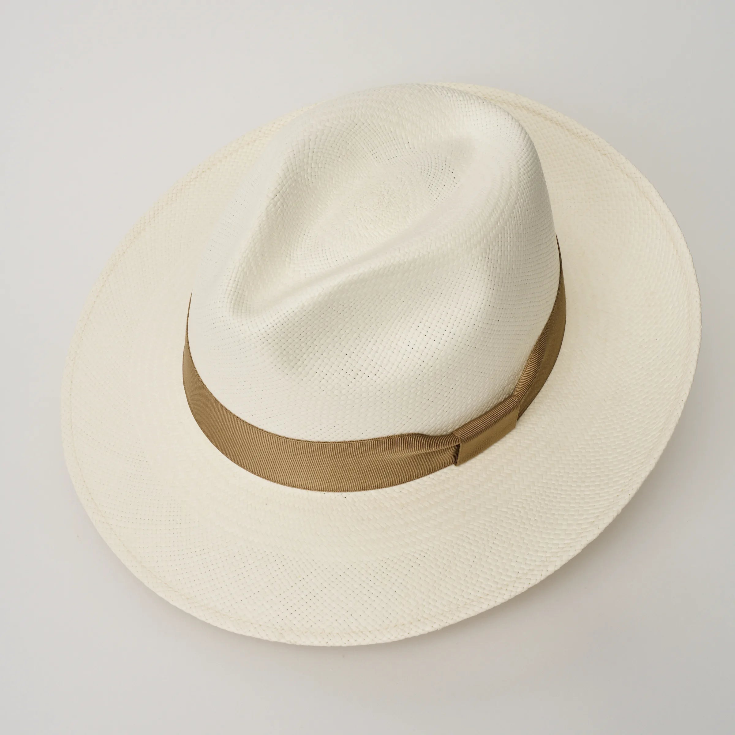 Studio image looking down on the Camilo Classic Cream coloured Panama Hat with Tan trim, showing the crown shape.