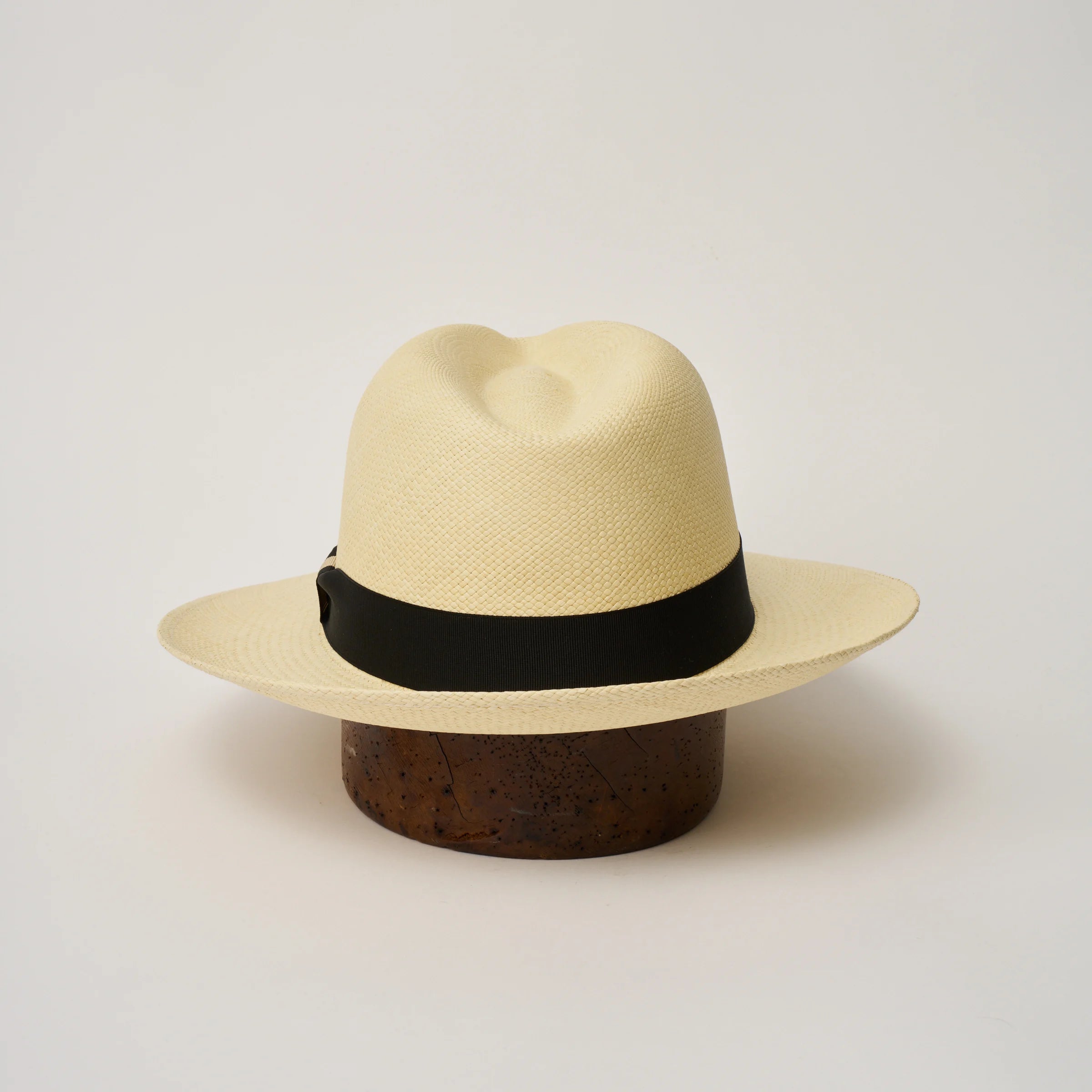 Studio image of the Camilo Classic Natural coloured Panama Hat with Black trim shown from the back, showing the snapback brim.
