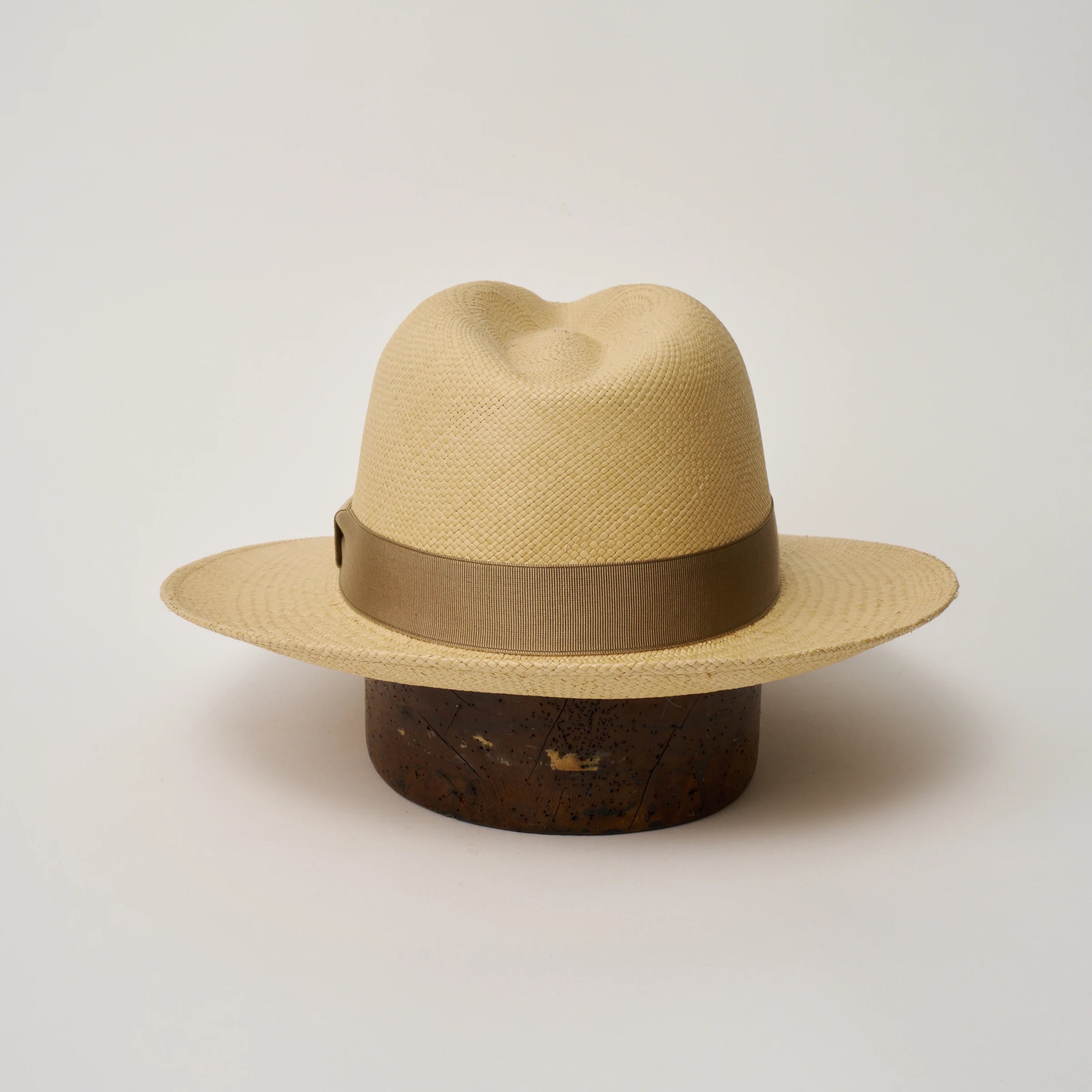 Studio image of the Camilo Classic Sand coloured Panama Hat with Taupe trim shown from the back, showing the snapback brim.