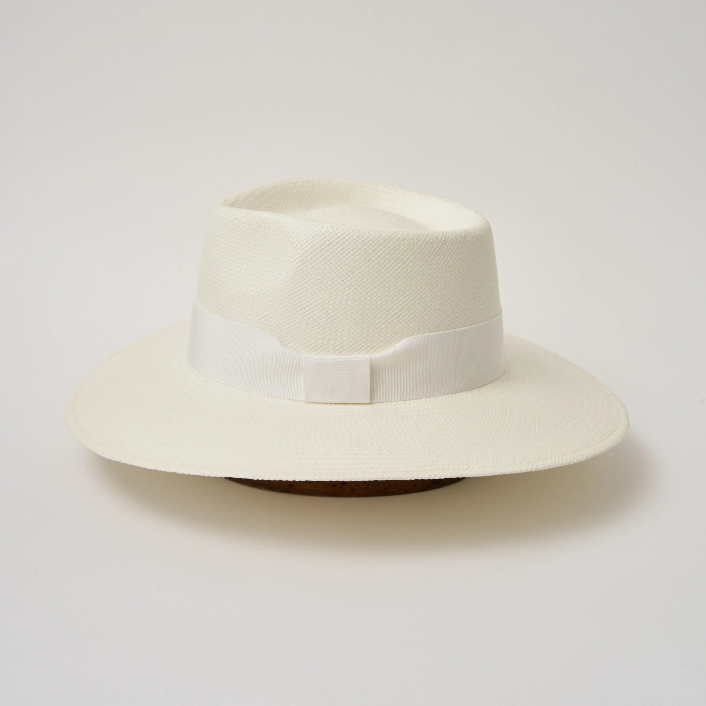Studio image of the Camilo Country Cream coloured Panama Hat with White trim taken from the side, showing brim and ribbon finish.