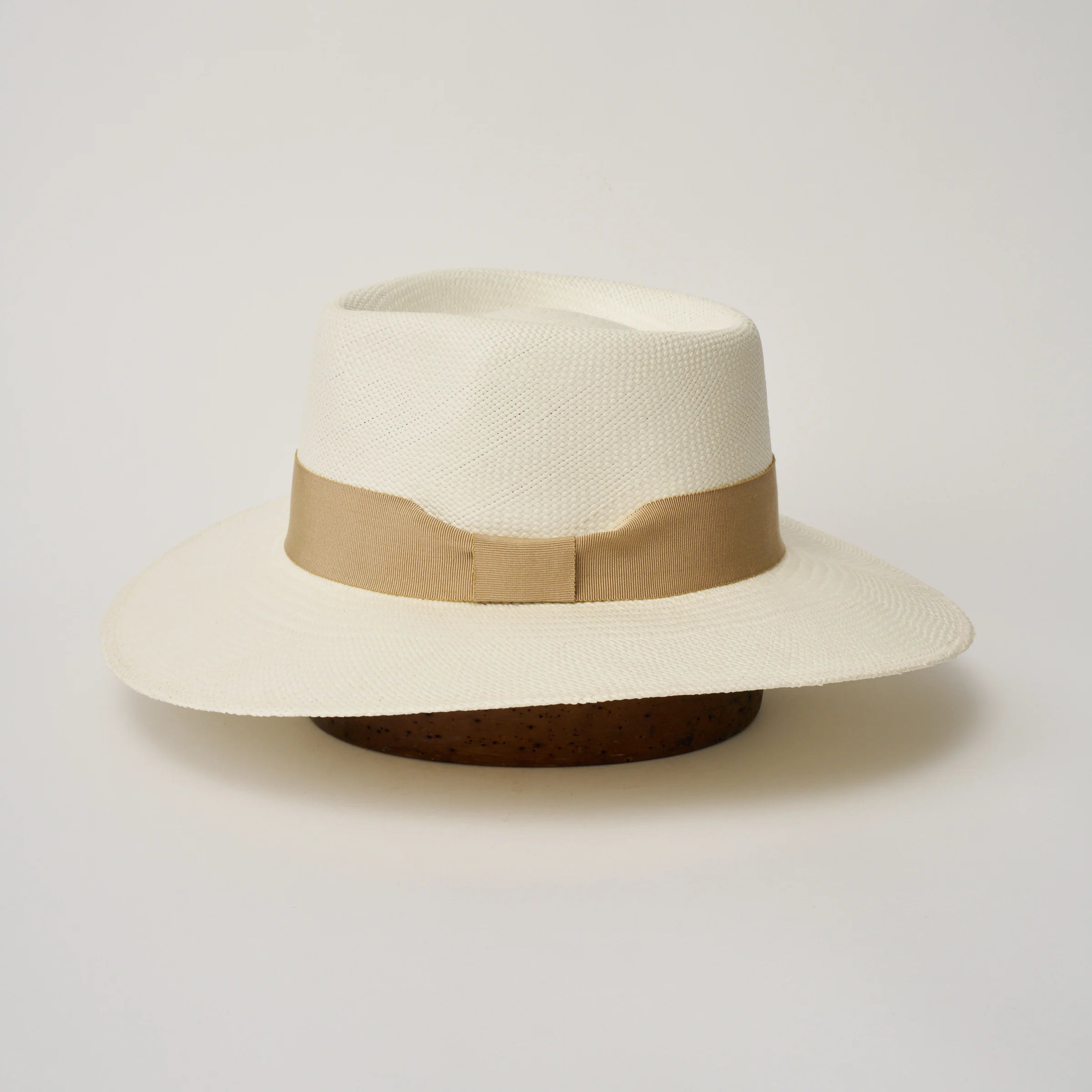 Studio image of the Camilo Country Cream coloured Panama Hat with Camel trim taken from the side, showing brim and ribbon finish.