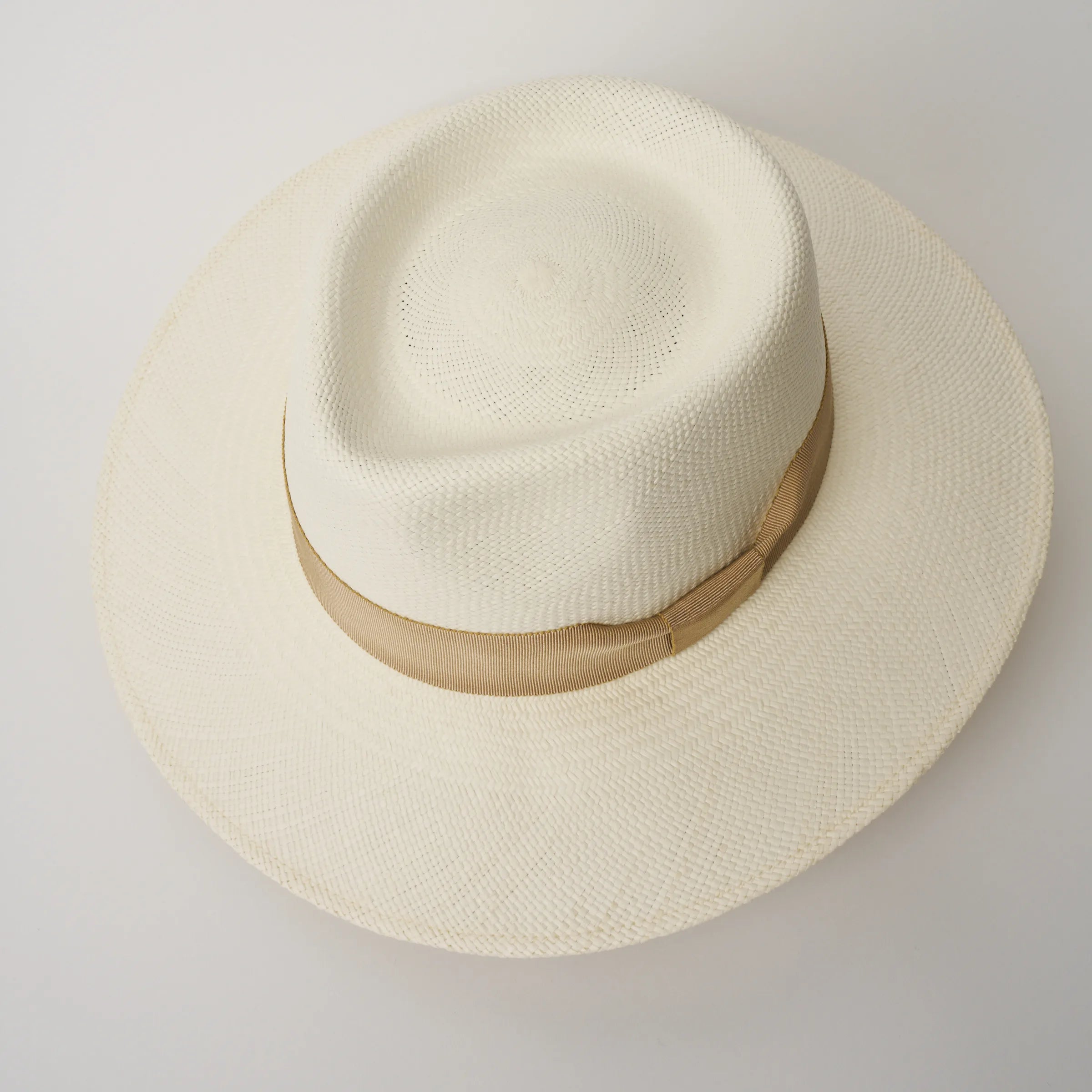 Studio image, taken looking down at the Camilo Country Cream coloured Panama Hat with Camel trim, showing the crown shape and pinch.
