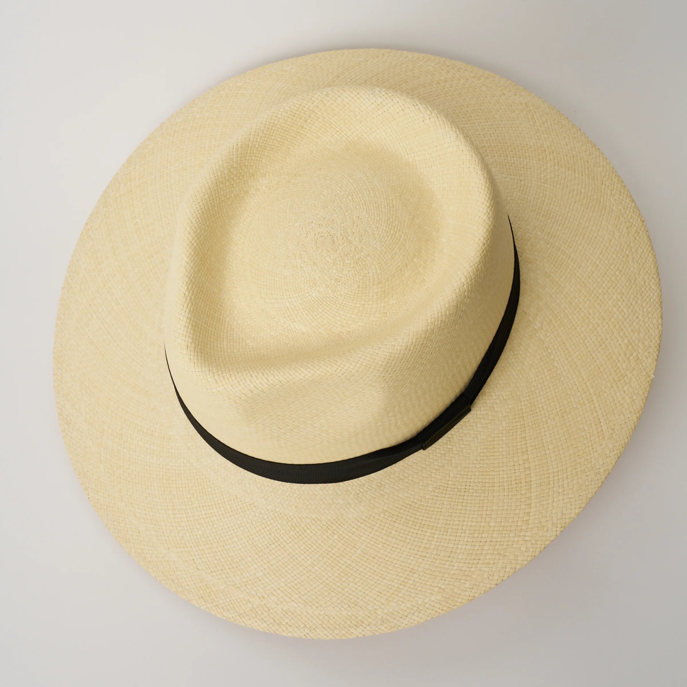 Studio image, looking top-down on the Camilo Country Natural coloured Panama Hat with Black trim, showing the crown shape.