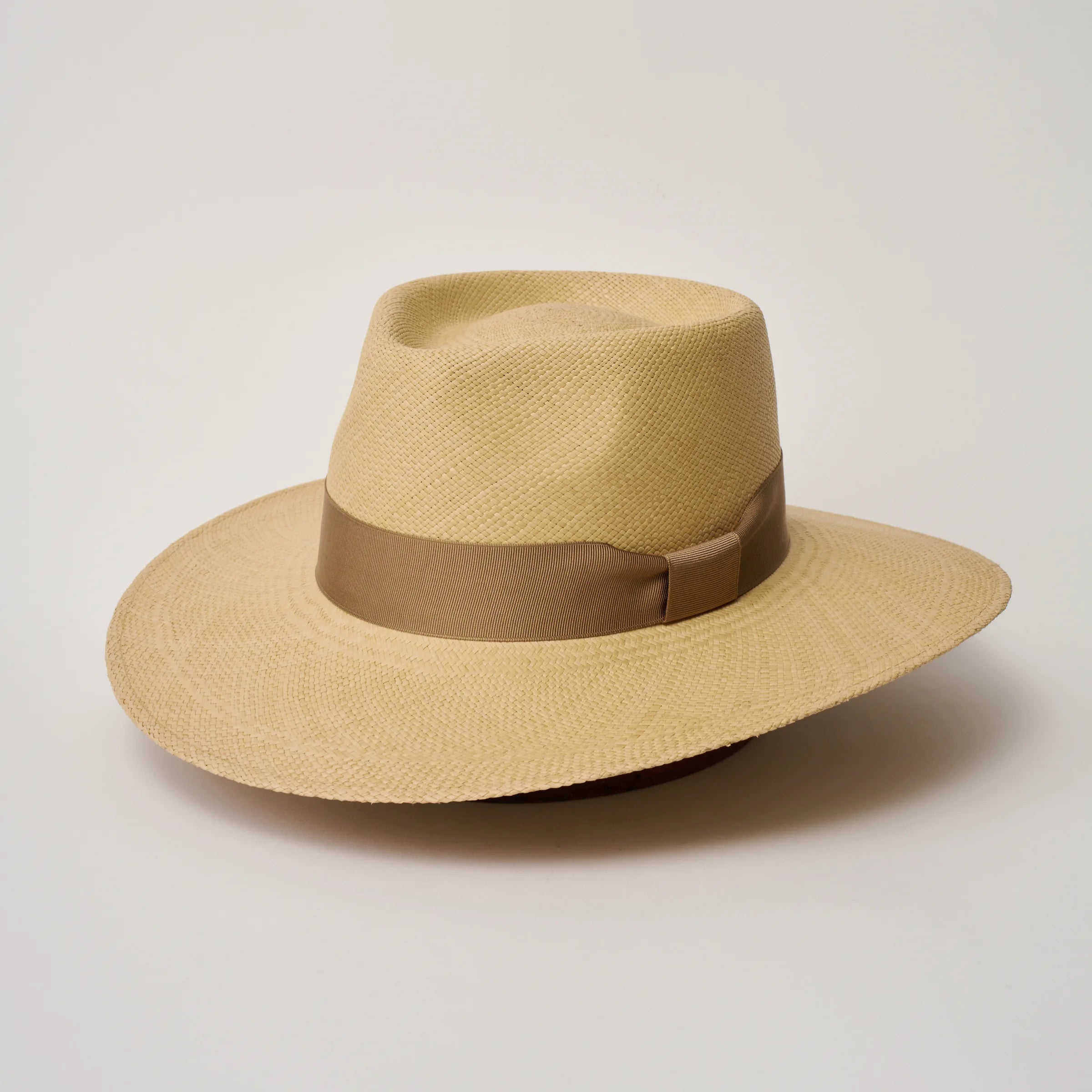 Studio image of the Camilo Country Sand coloured Panama Hat with Tan trim, angled showing the crown shape, front crease and ribbon details.