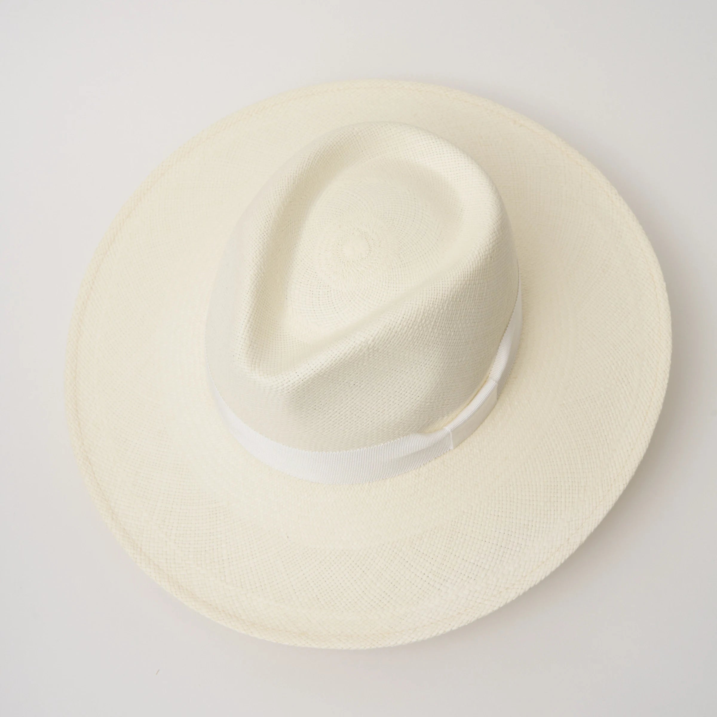 Studio image, taken looking down at the Camilo Oro Cream coloured Panama Hat with White trim, showing the crown shape and pinch.