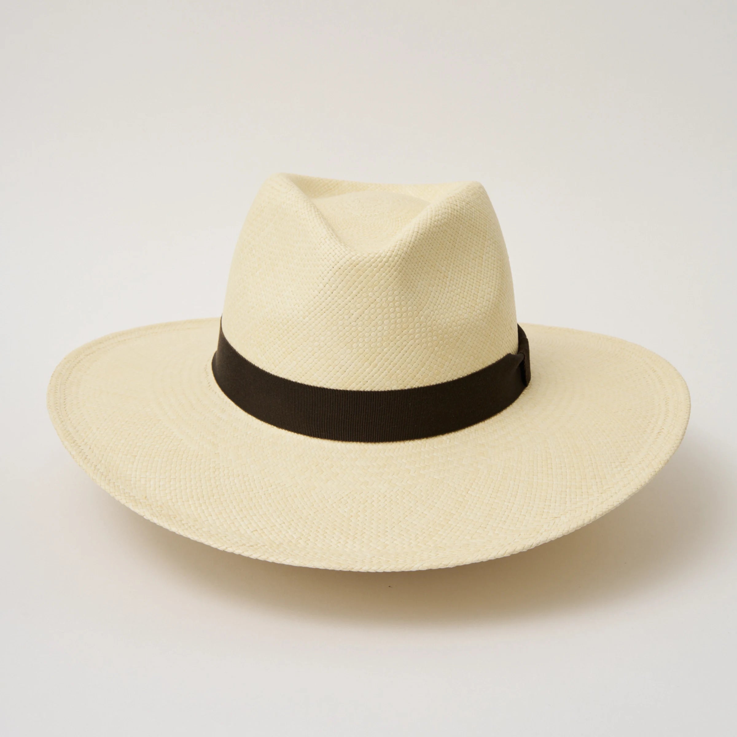 Studio image of the Camilo Oro Natural coloured Panama Hat with Espresso trim taken from the front showing pinch and brim.