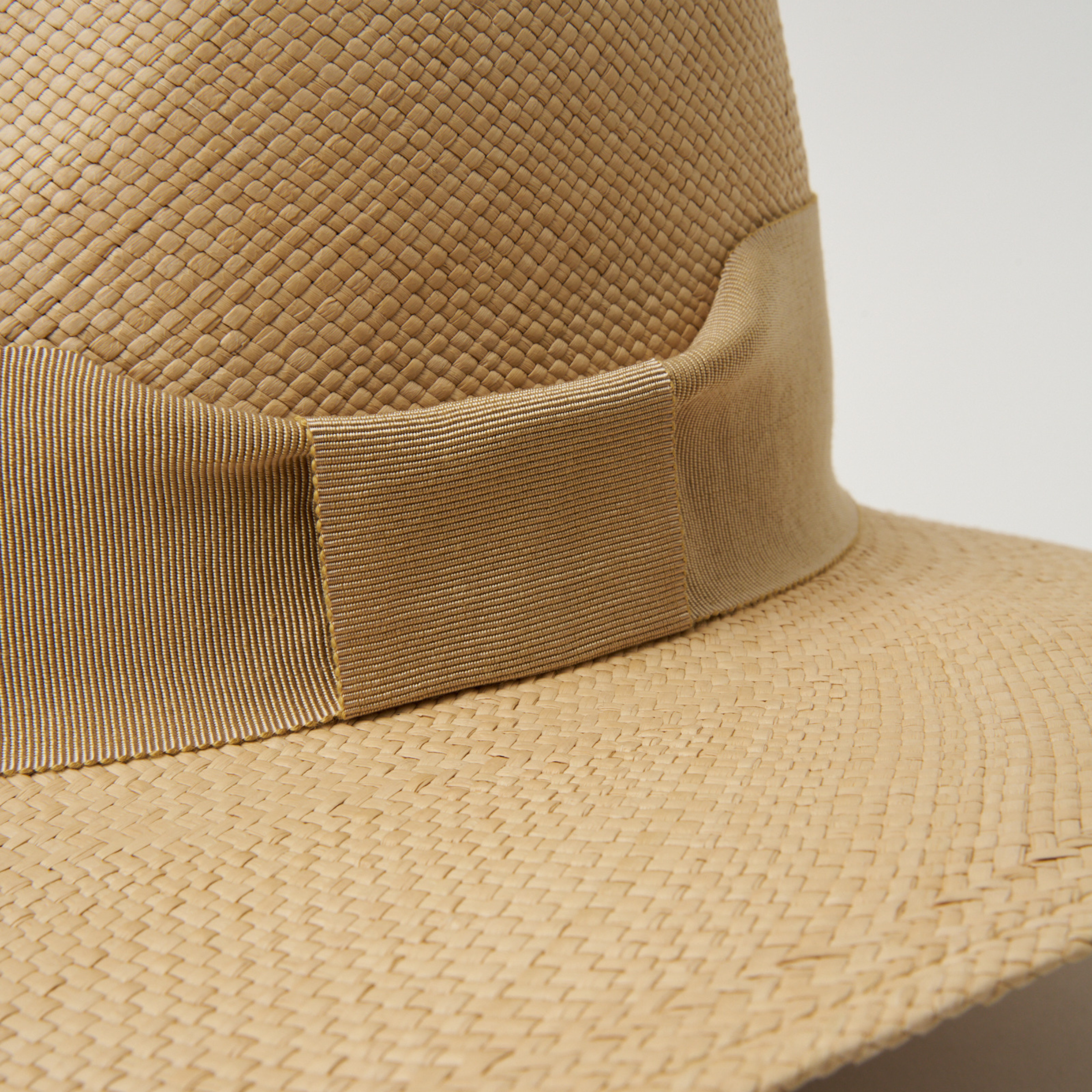 Studio closeup image of the Camel ribbon trim detail on the Sand coloured Camilo Oro Panama hat.