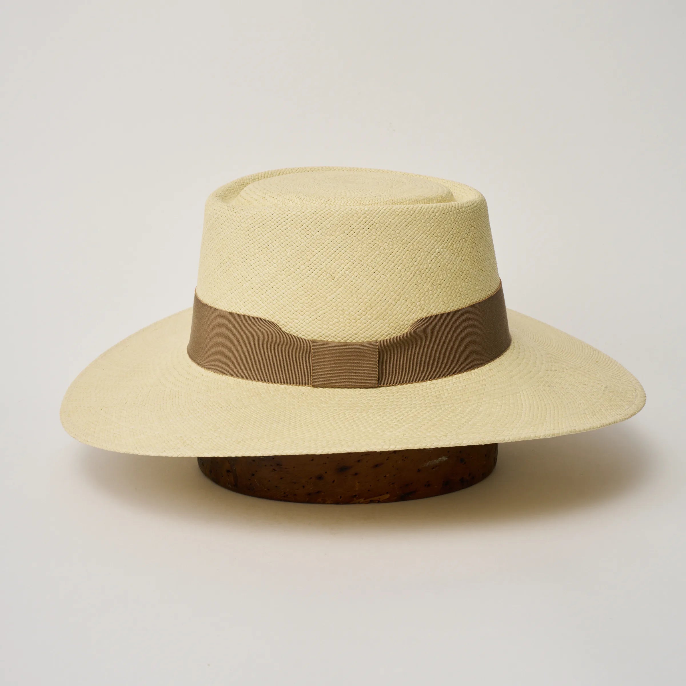 Studio image of the Camilo Sol
Natural coloured Panama Hat with Oat trim shown from the side, showing the brim shape and ribbon finish.