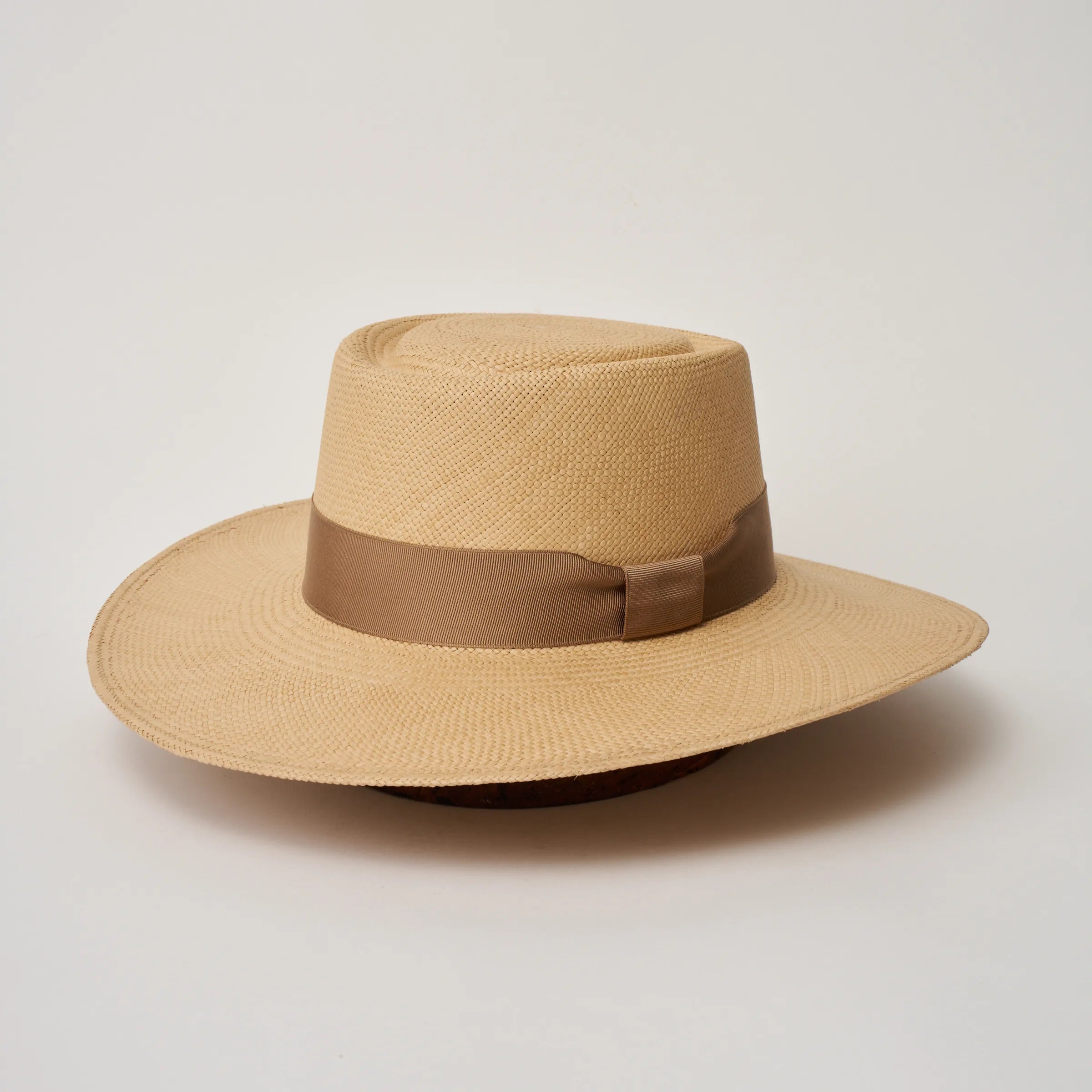 Studio image of the Camilo Sol Sand coloured Panama Hat with Tan trim, angled showing the crown shape and ribbon details.