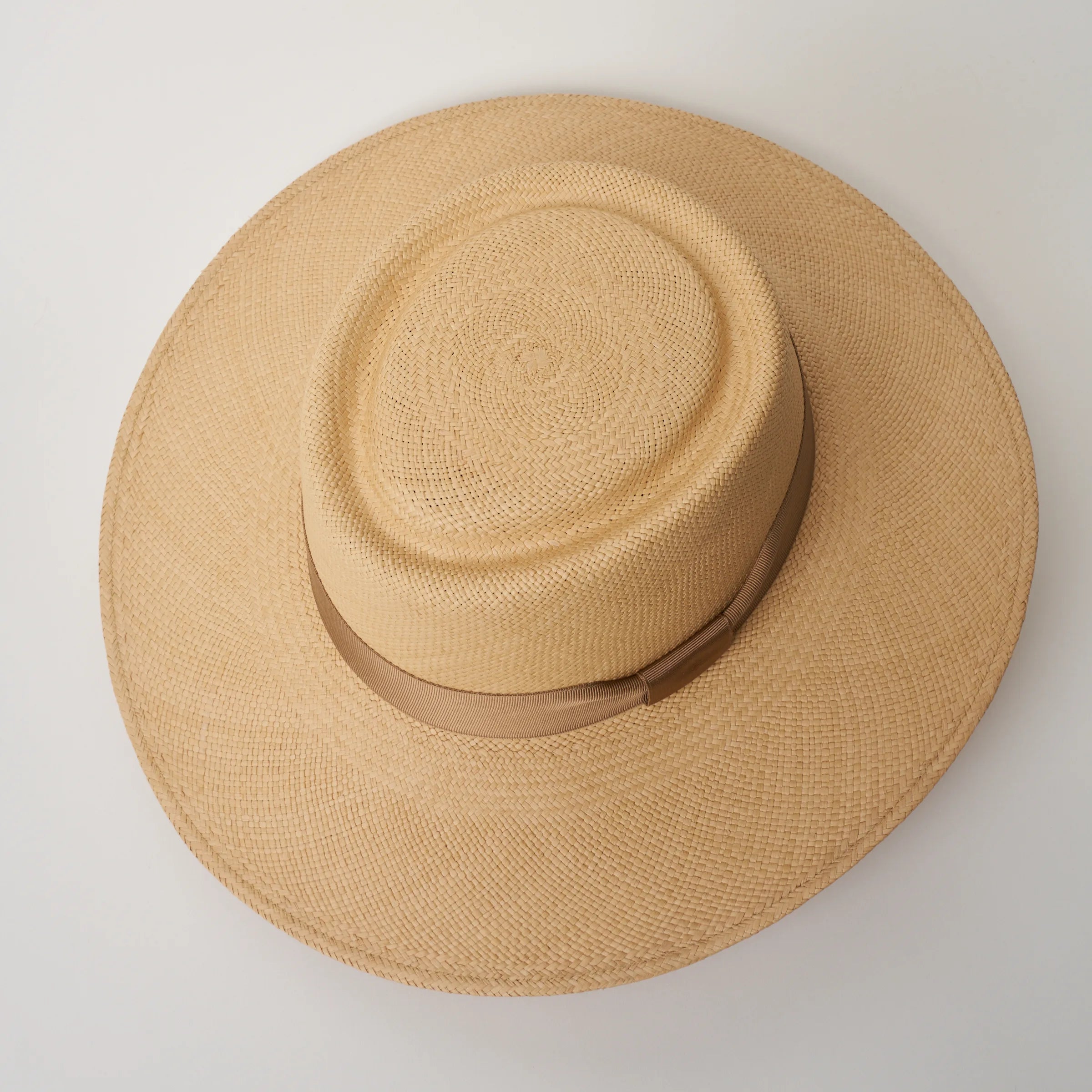 Studio image, looking top-down on the Camilo Sol Sand coloured Panama Hat with Tan trim, showing the crown shape.