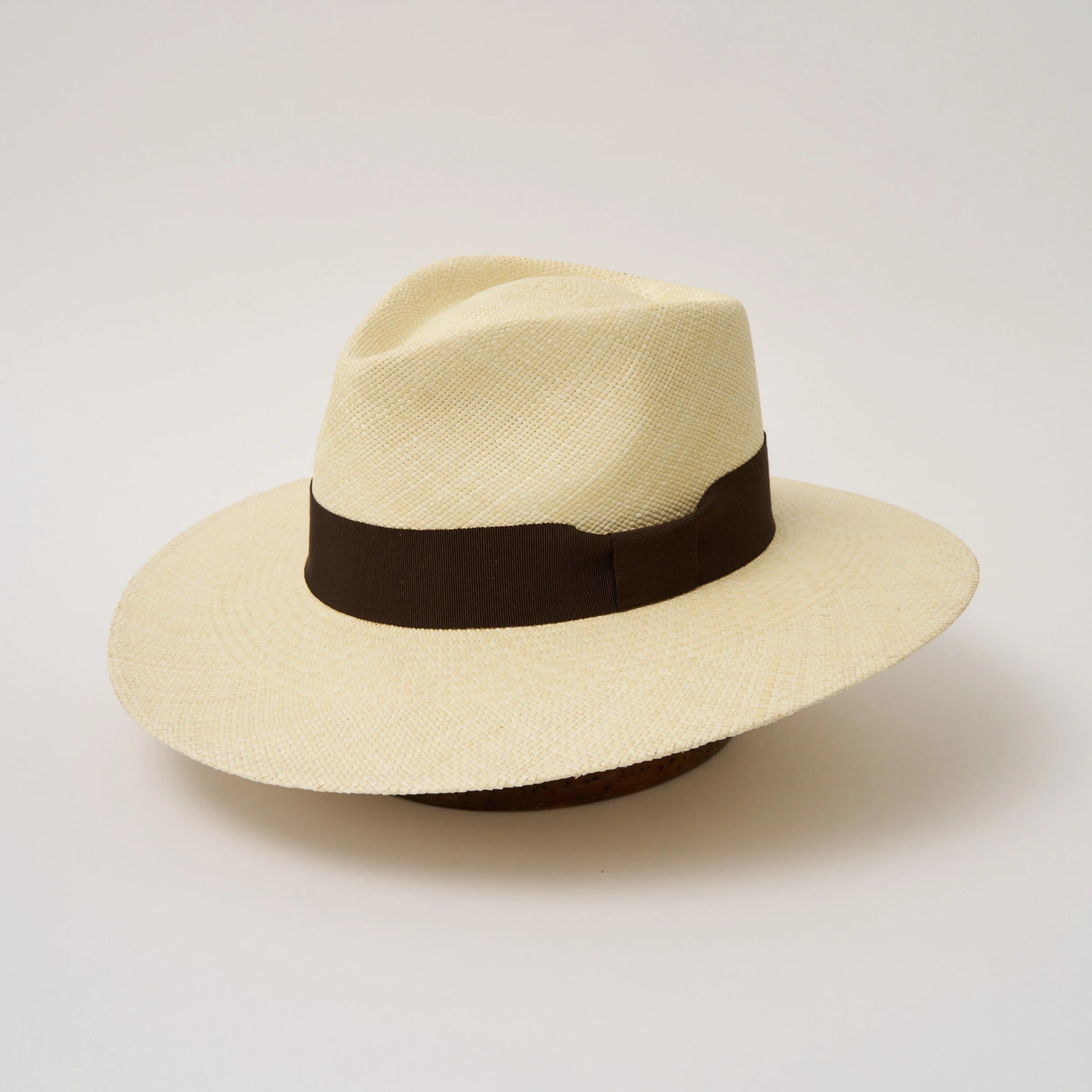 Studio image, angled view of the Camilo Vita Natural coloured Panama Hat with Chocolate trim, showing the overall hat shape.