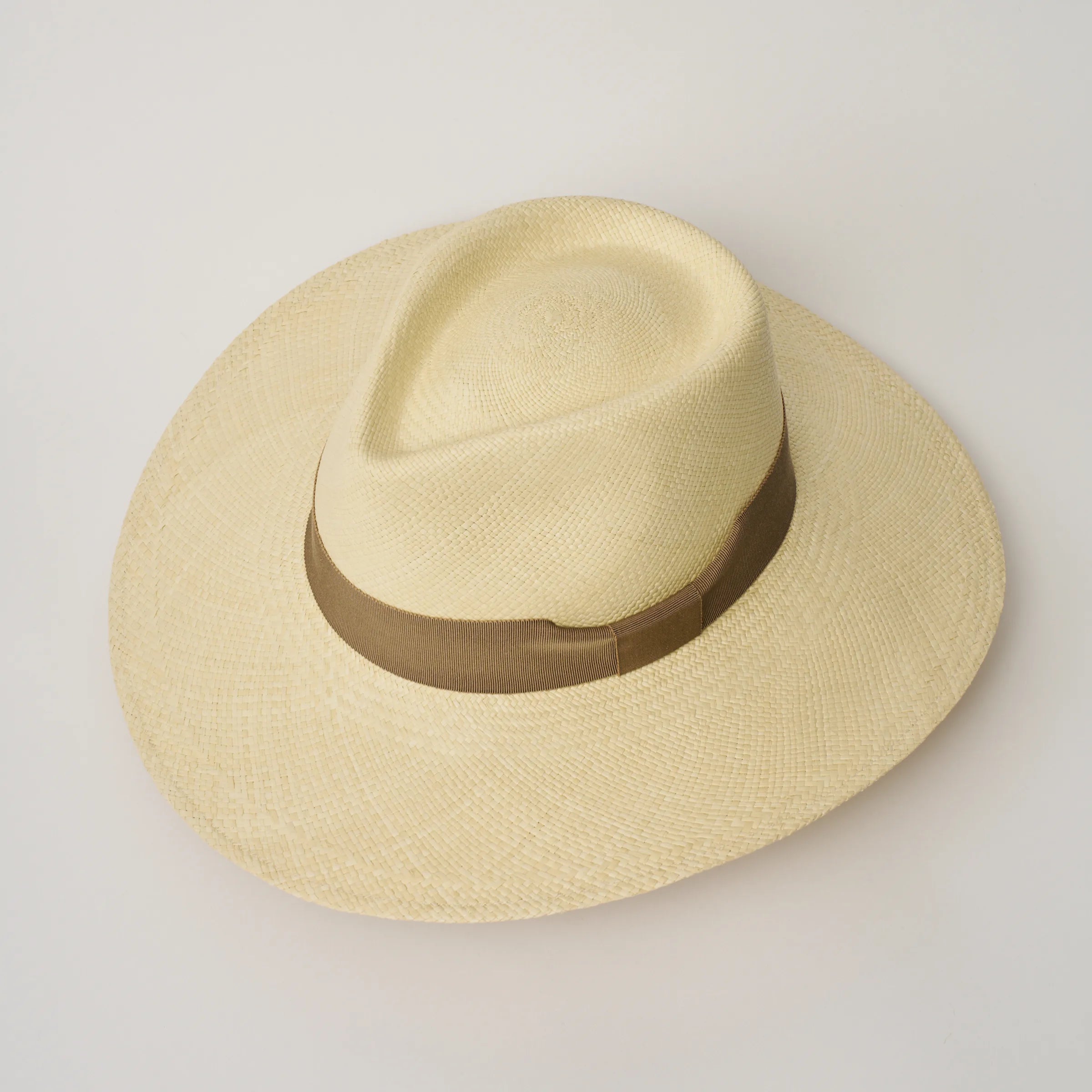 Studio image, taken looking down at the Camilo Vita Natural coloured Panama Hat with Oat trim, showing the crown shape and pinch.
