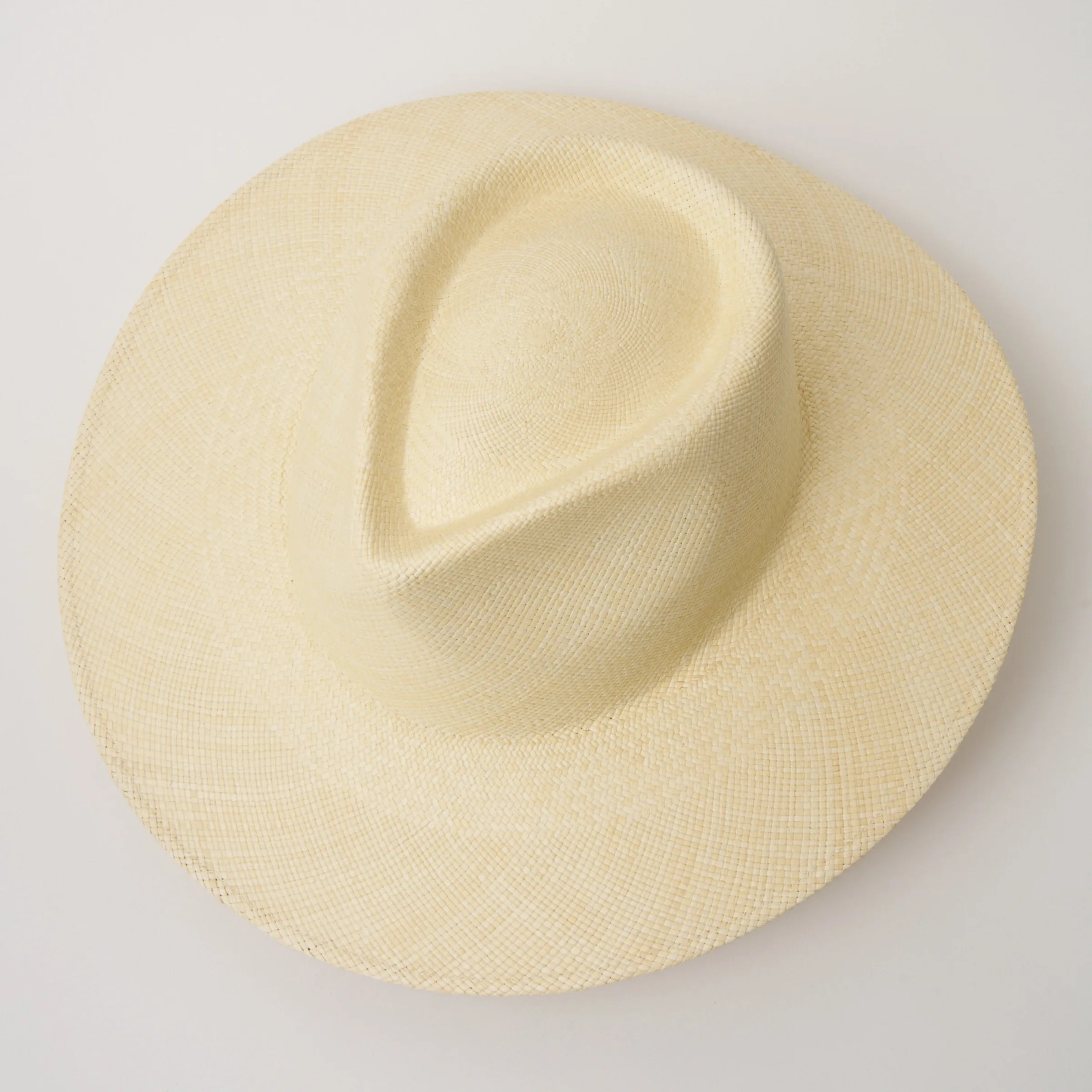 Studio image, taken looking down at the Camilo Vita Natural coloured Panama Hat, showing the crown shape and pinch.