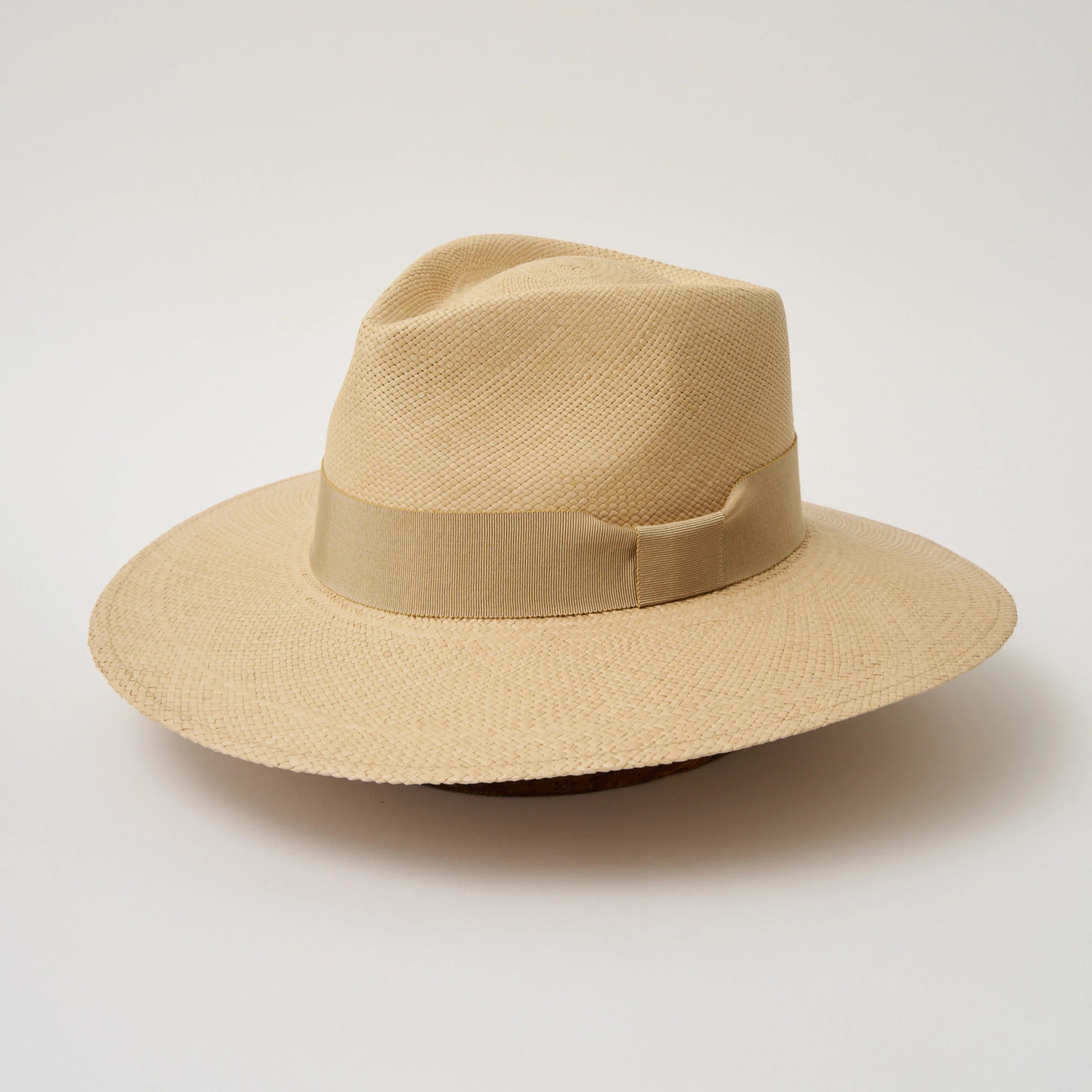Studio image, angled view of the Camilo Vita Sand coloured Panama Hat with Camel trim, showing the overall hat shape.