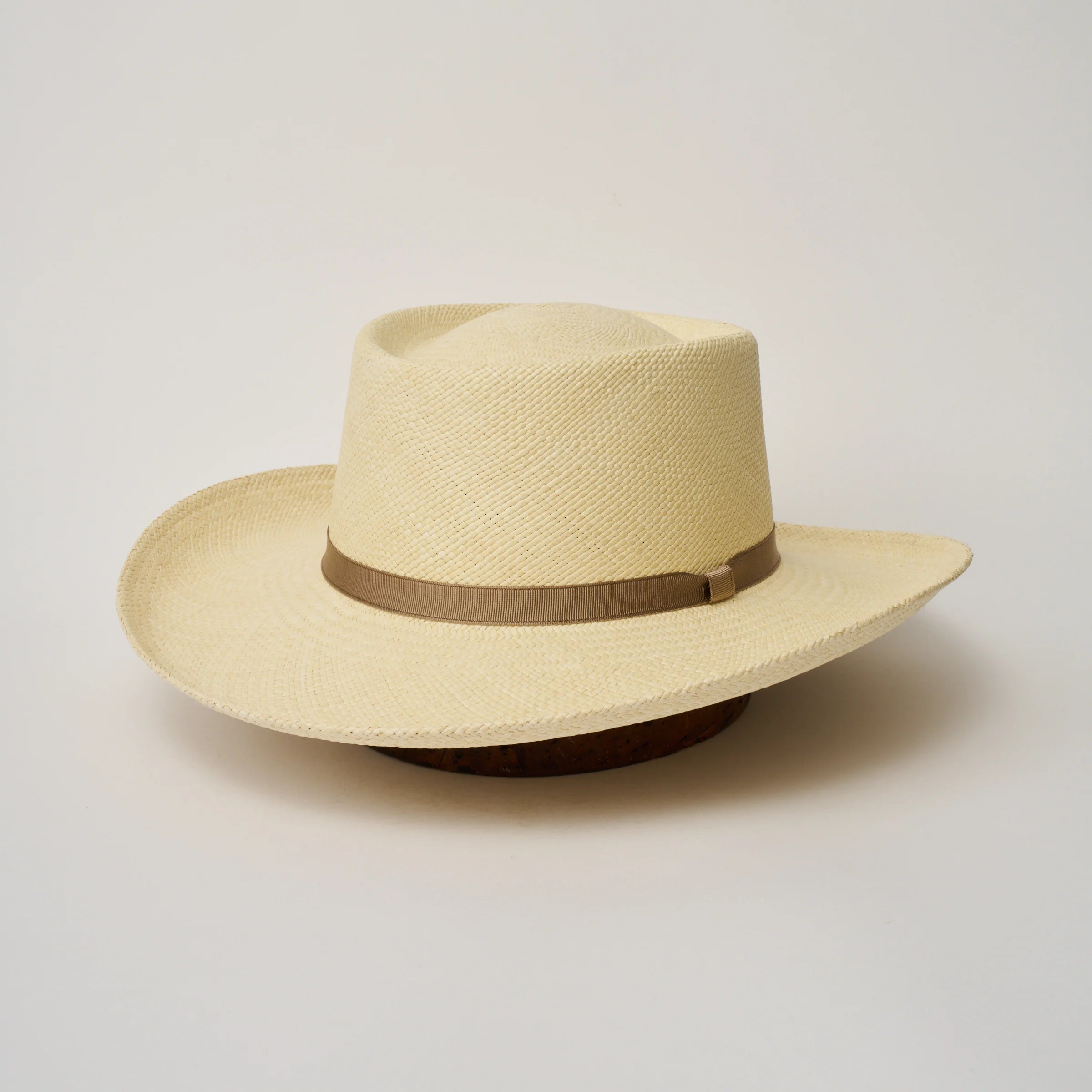 Studio image of the Camilo Gambler Natural coloured Panama Hat with Taupe trim, angled showing the crown shape, front crease and ribbon details.