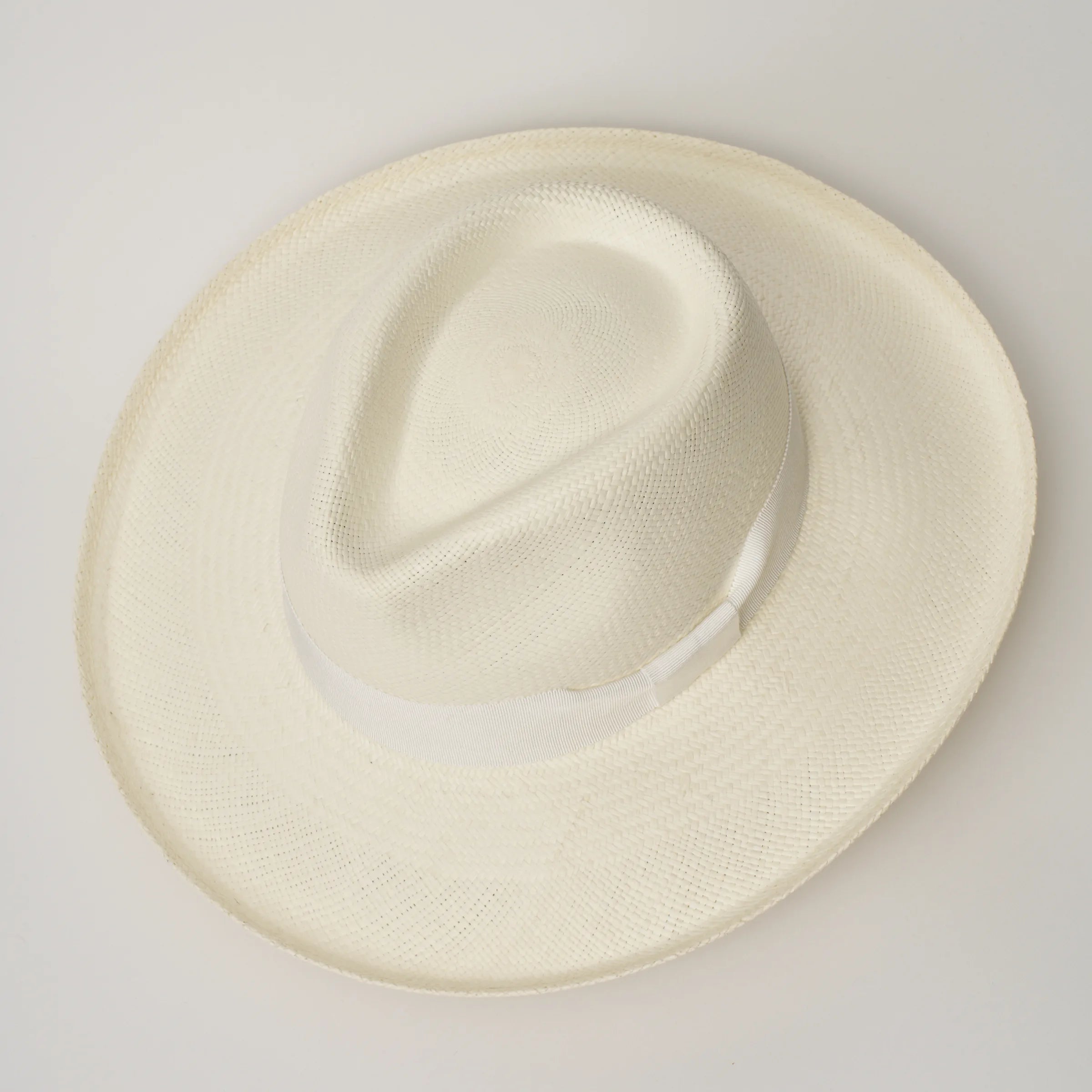 Studio image, looking top-down on the Camilo Grand Planter Cream coloured Panama Hat with White trim, showing the crown shape.