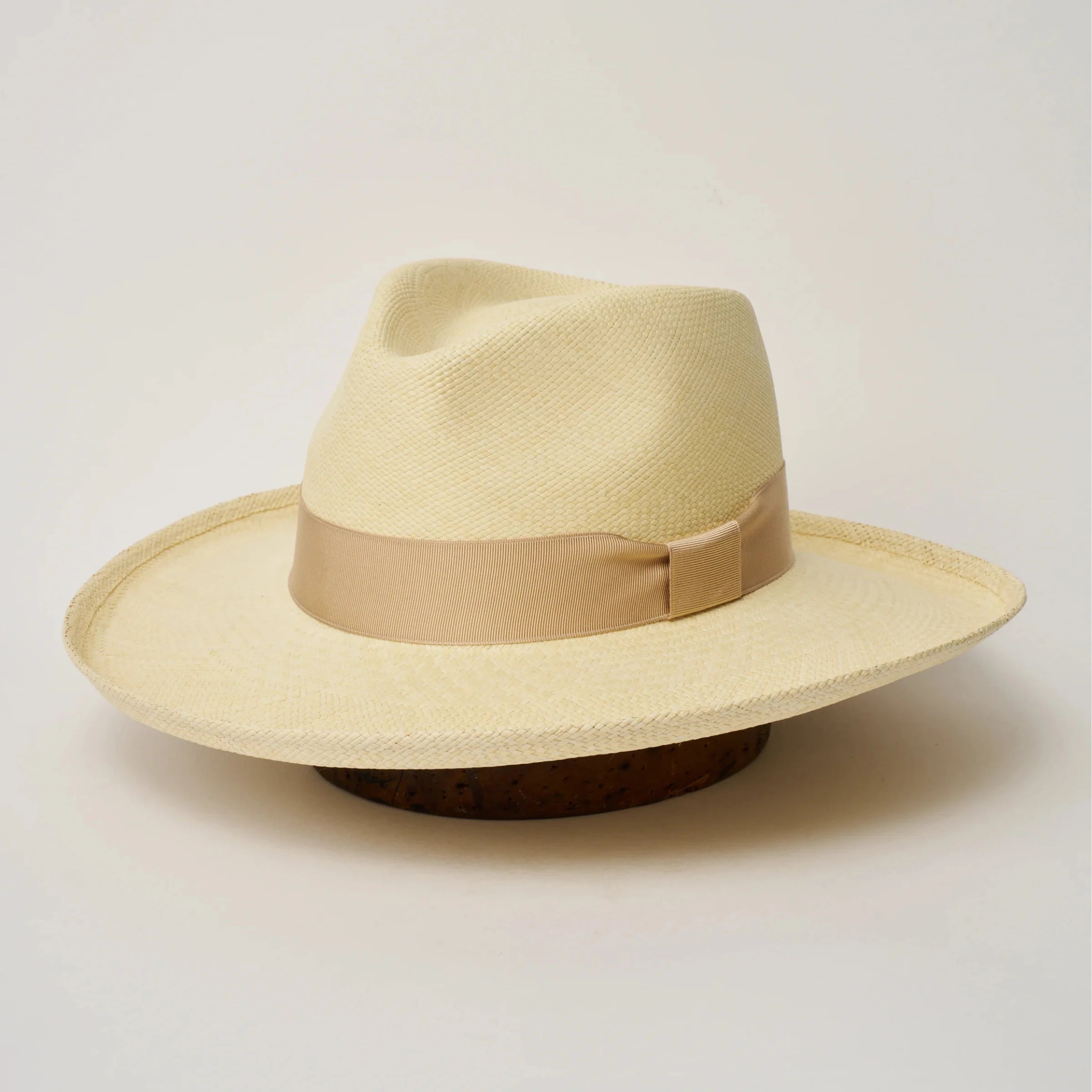 Studio image of the Camilo Grand Planter Natural coloured Panama Hat with Bone trim, angled showing the crown shape, front crease and ribbon details.