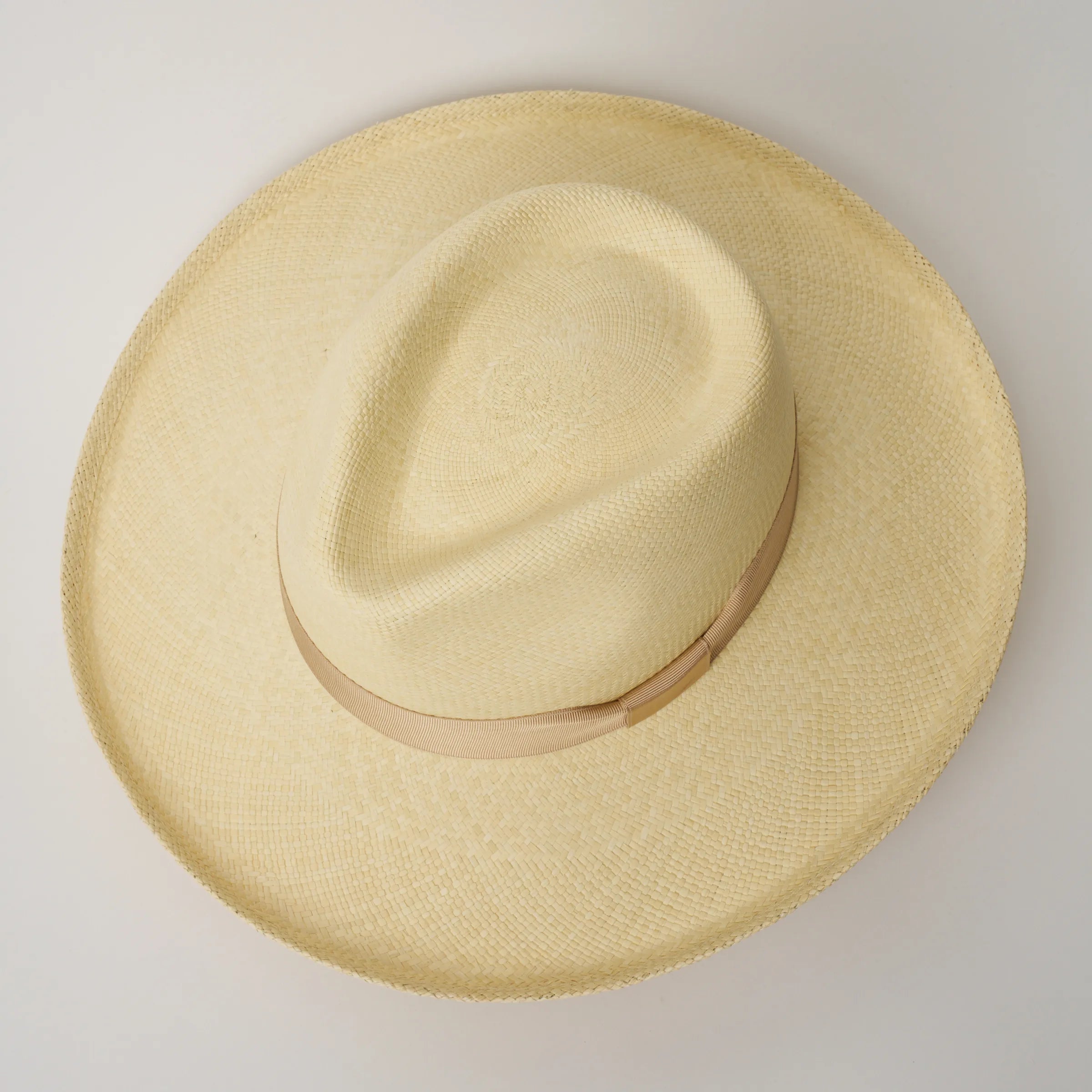 Studio image, looking top-down on the Camilo Grand Planter Natural coloured Panama Hat with Bone trim, showing the crown shape.
