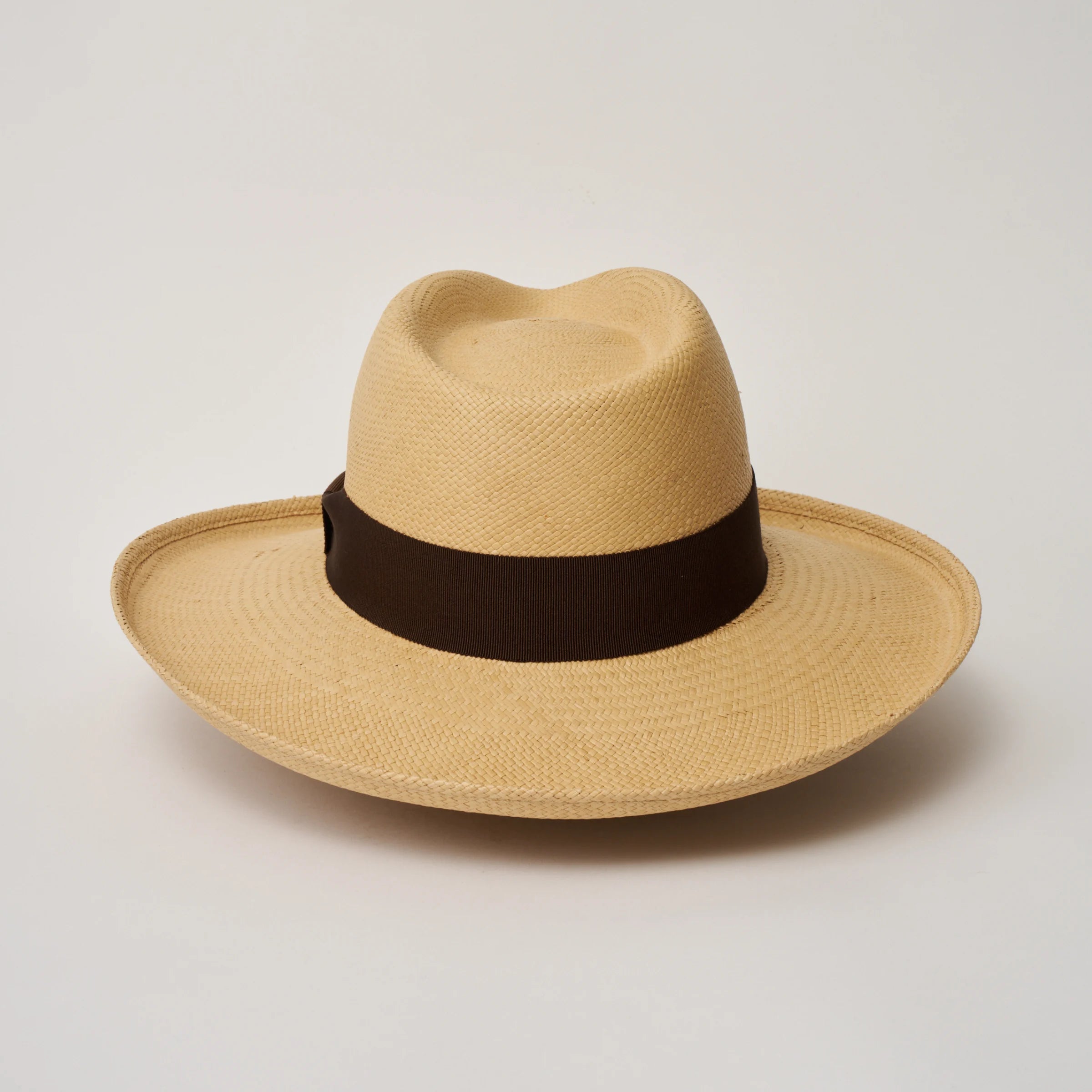 Studio image of the Camilo Grand Planter Sand coloured Panama Hat with Chocolate trim taken from the back.