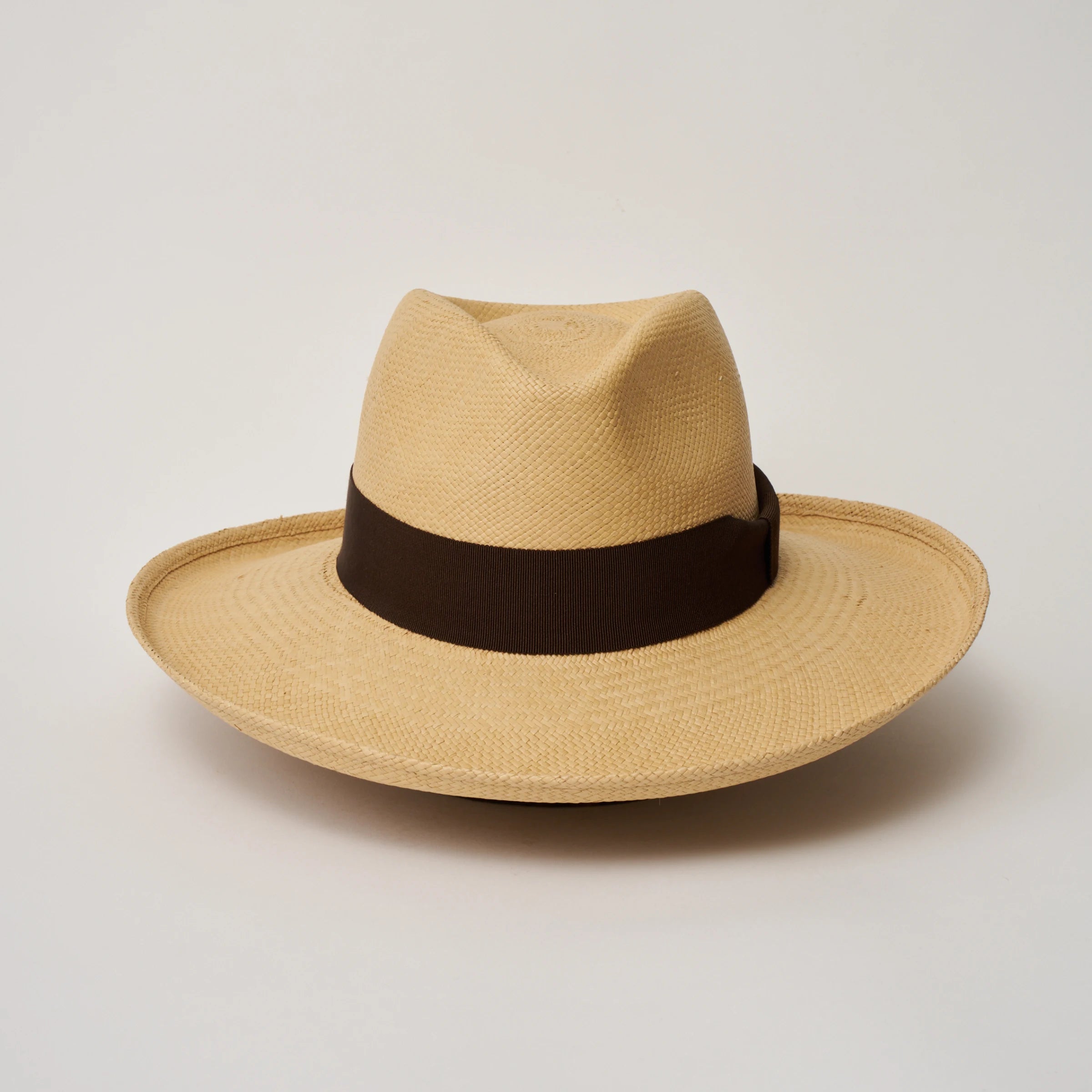 Studio image, looking top-down on the Camilo Grand Planter Sand coloured Panama Hat with Chocolate trim, showing the crown and brim shape.