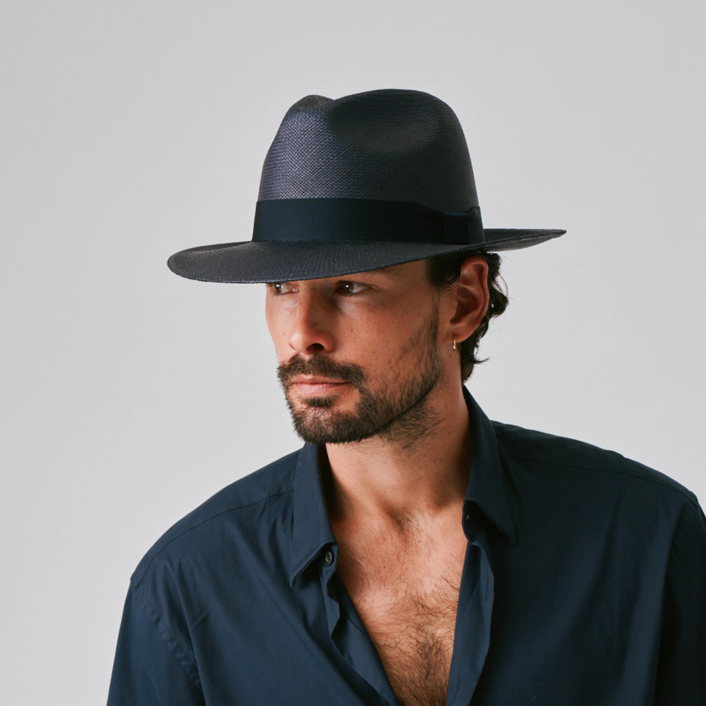 Man wearing a Camilo Classic Navy / Marine Panama hat against a plain background.