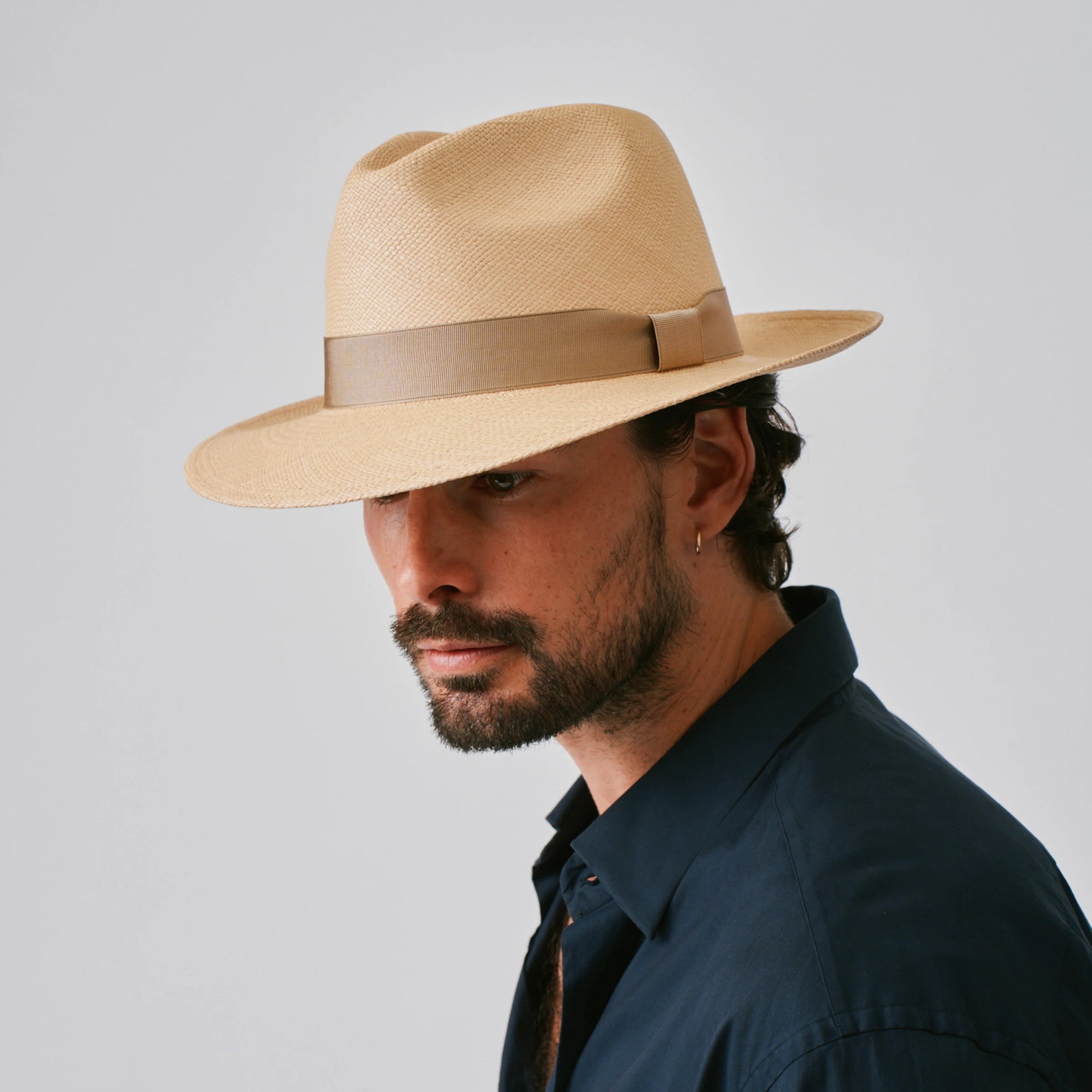 Man wearing a Camilo Classic Sand / Taupe Panama hat against a plain background.