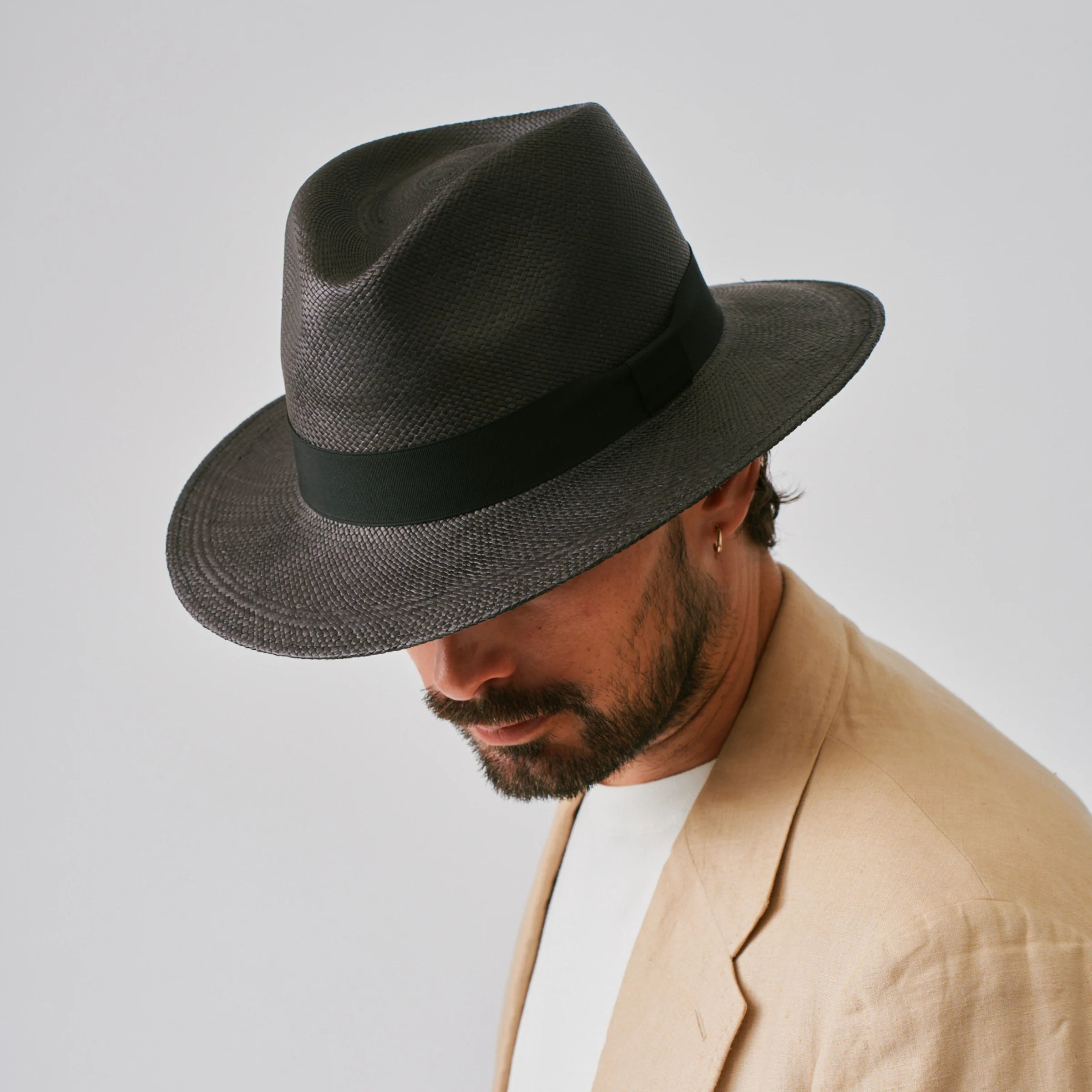 Man wearing a Executive Black / Black Panama hat against a plain background.