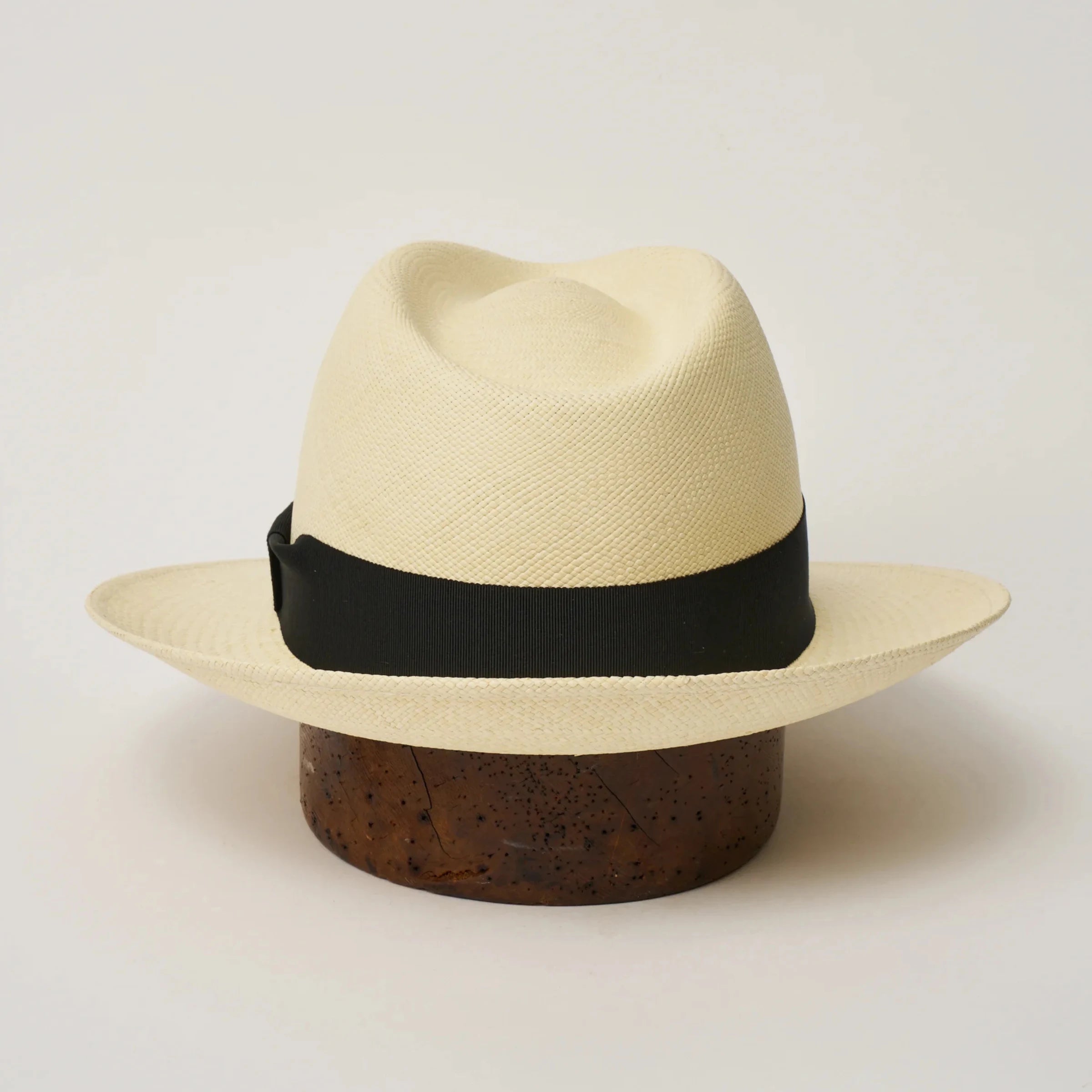 Studio image of the Camilo New Fedora Fino Natural coloured Panama Hat with Black trim shown from the back, showing snapback brim.