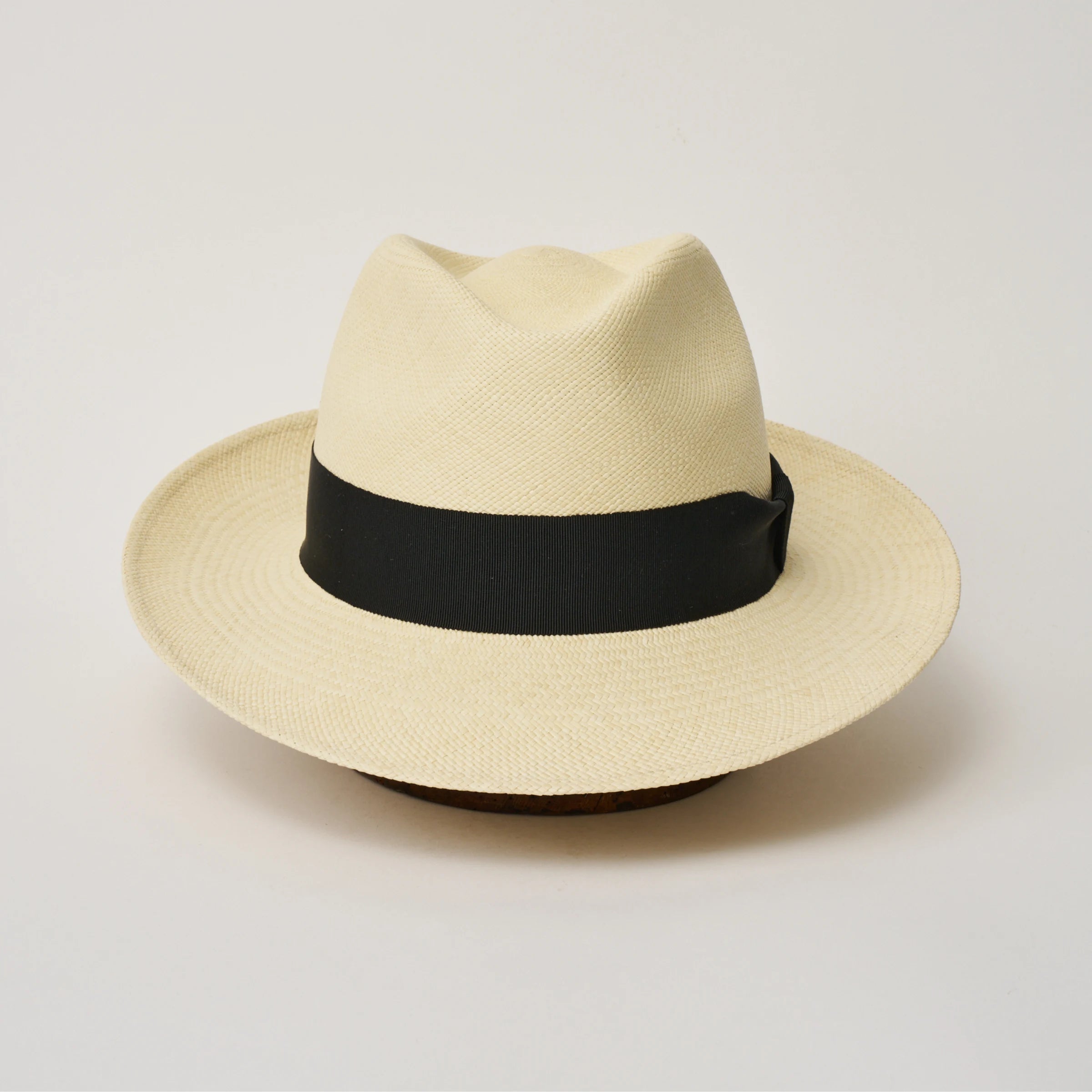 Studio image taken from the front, showing the Camilo New Fedora Fino Natural coloured Panama Hat with Black trim.