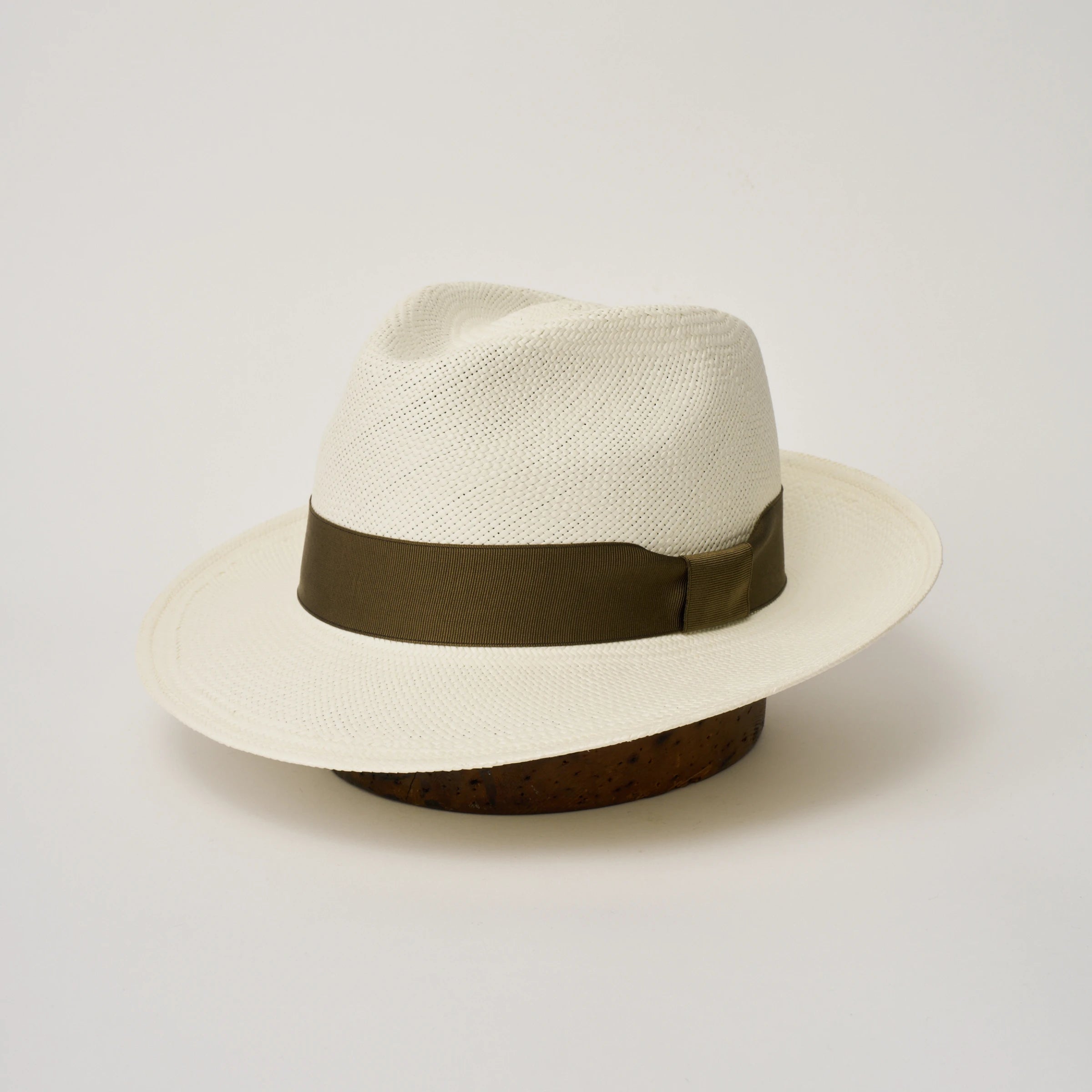 Studio image, three-quarter view of the Camilo New Fedora Cream coloured Panama Hat with Fawn trim, showing the crown shape, front crease and ribbon trim.