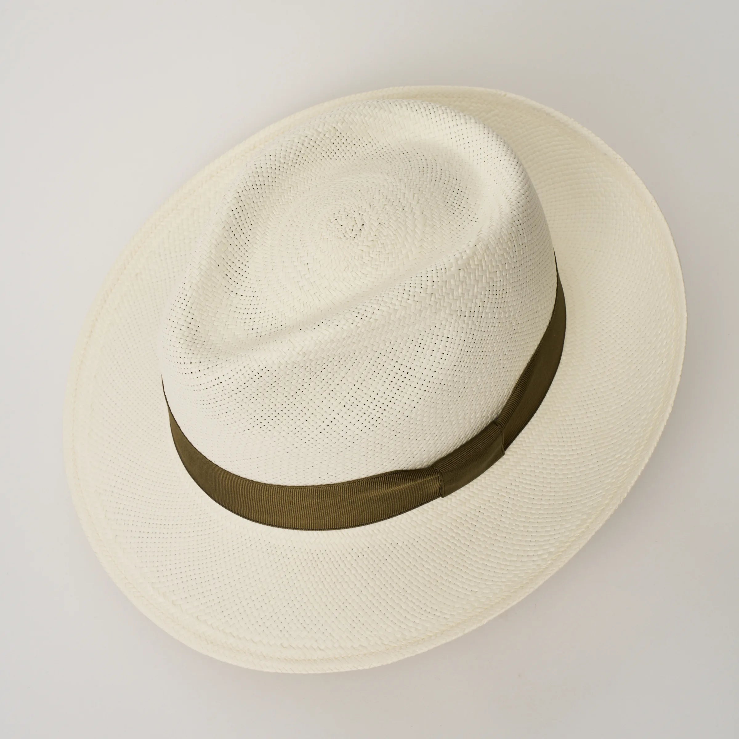 Studio image looking top-down, of the Camilo New Fedora Cream coloured Panama Hat with Fawn trim, showing the crown shape and weave details.