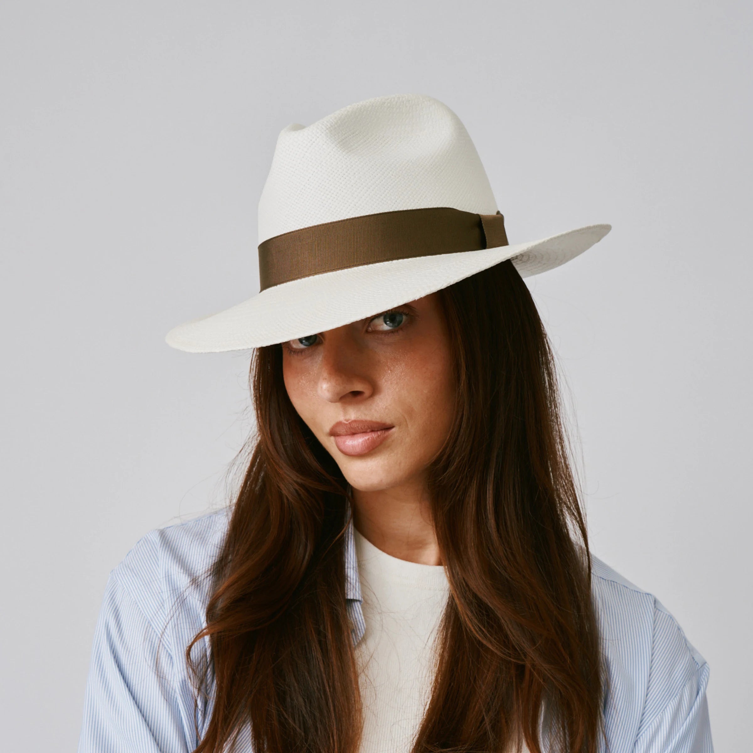 Woman wearing a Camilo Classic Cream / Fawn Panama hat against a plain background.