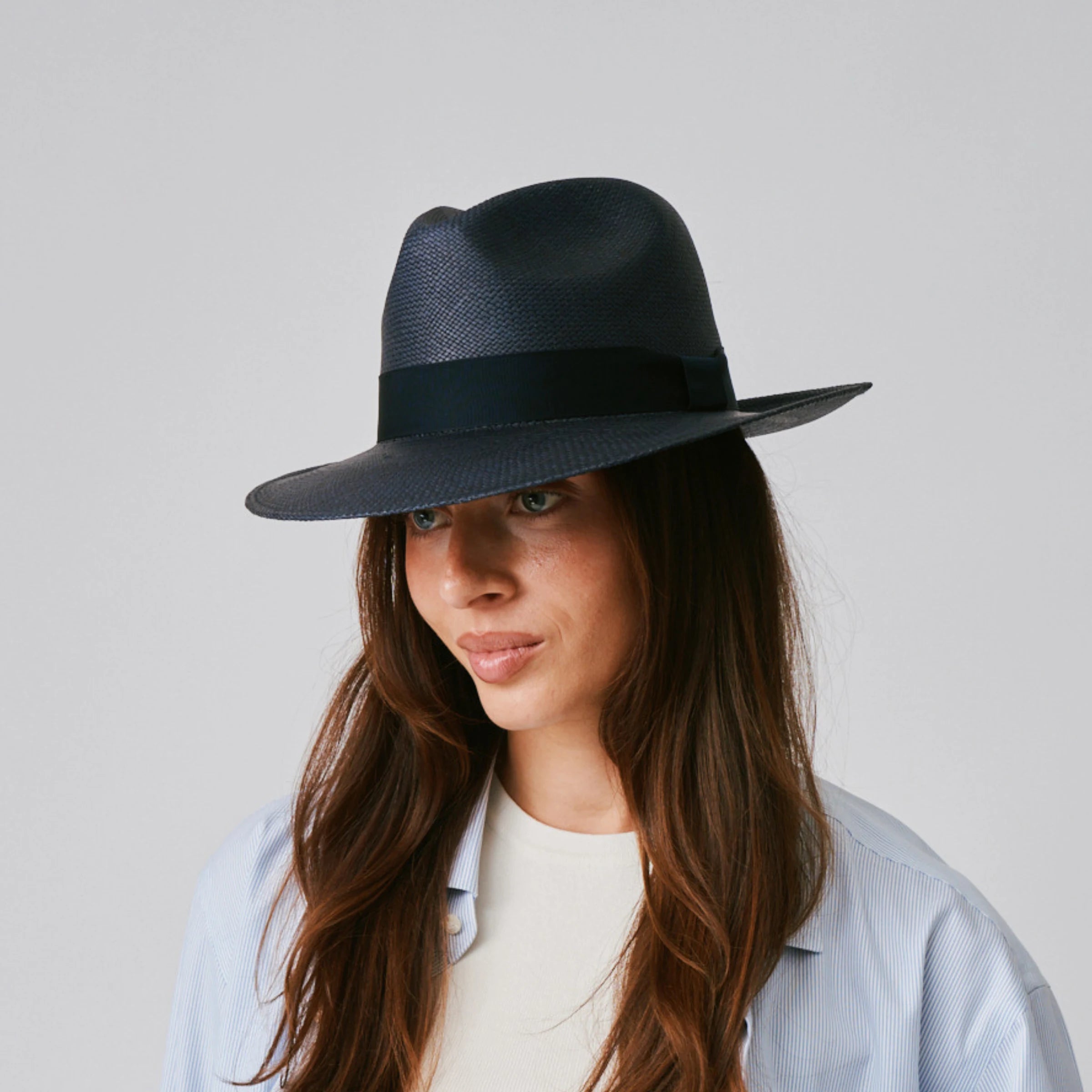 Woman wearing a Camilo Classic Navy / Marine Panama hat against a plain background.