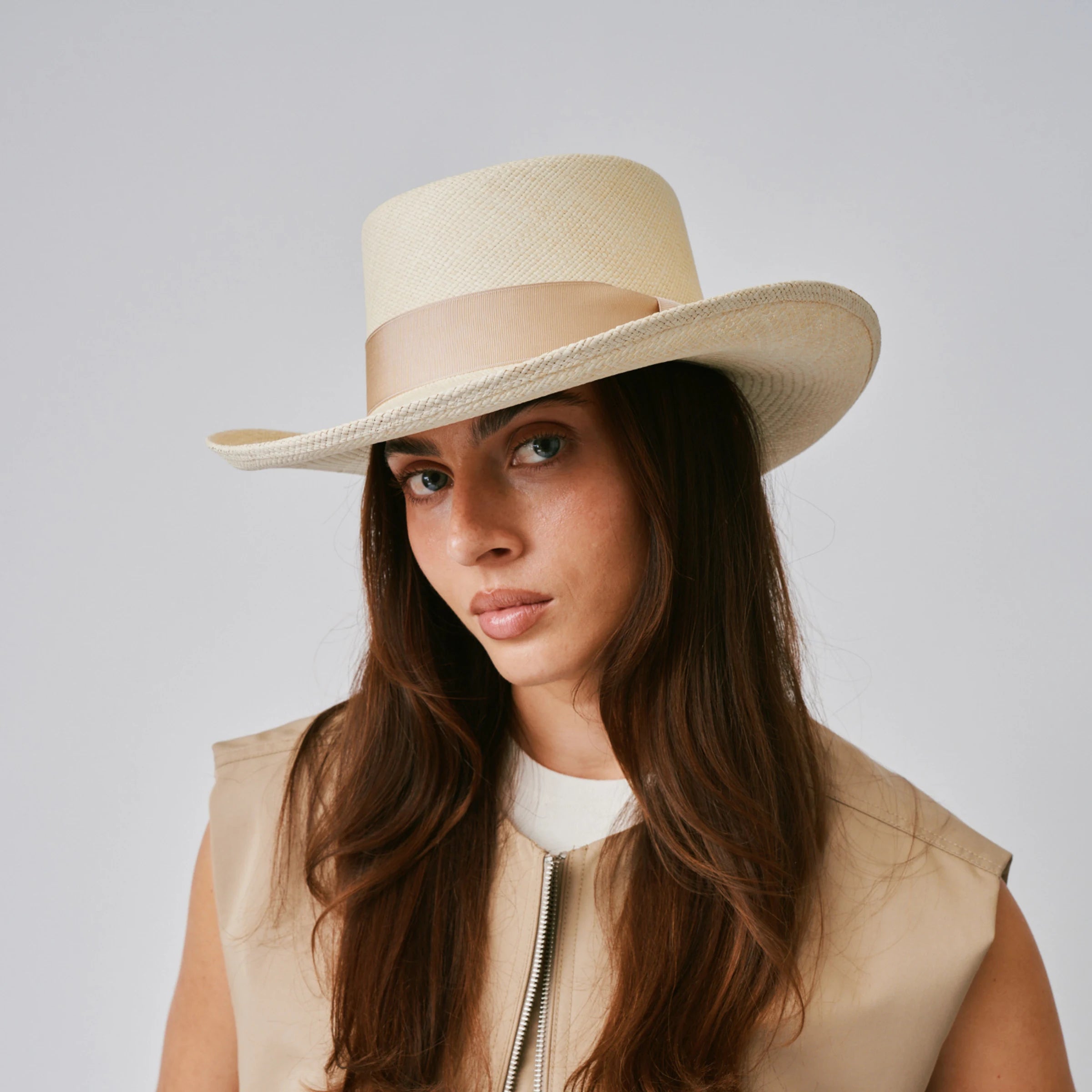 Woman wearing a Gambler Natural / Bone Panama hat against a plain background.