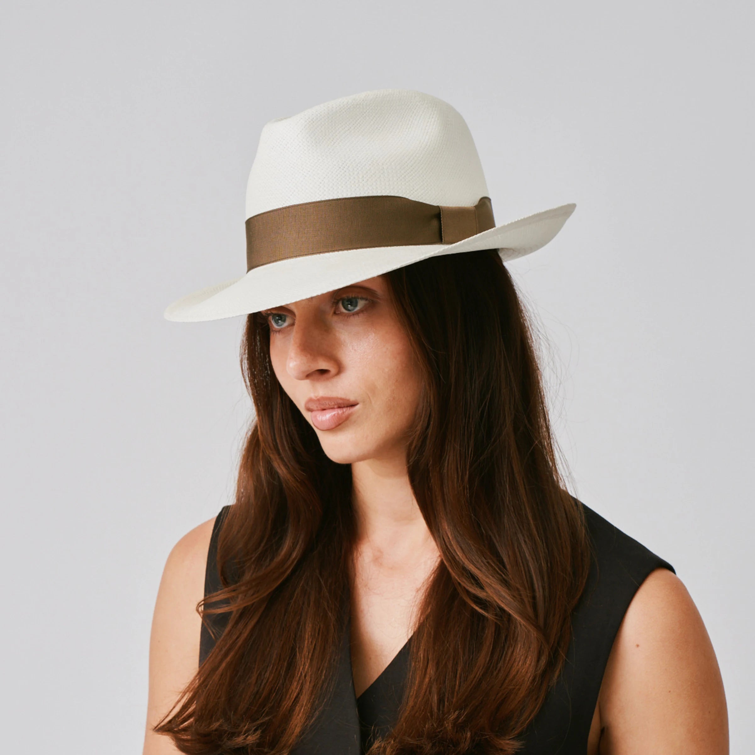 Woman wearing a New Fedora Cream / Fawn Panama hat against a plain background.