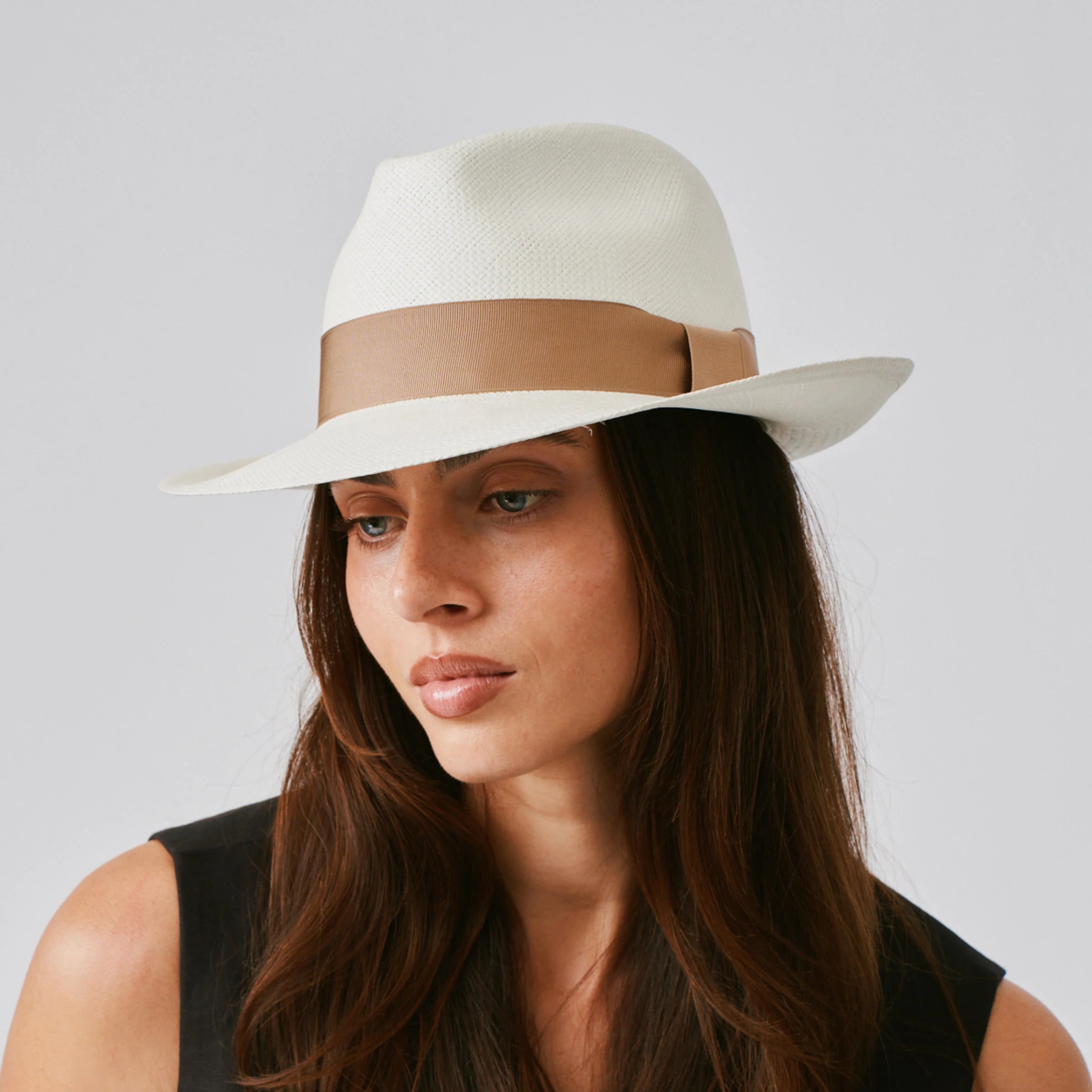 Woman wearing a New Fedora Cream / Tan Panama hat against a plain background.