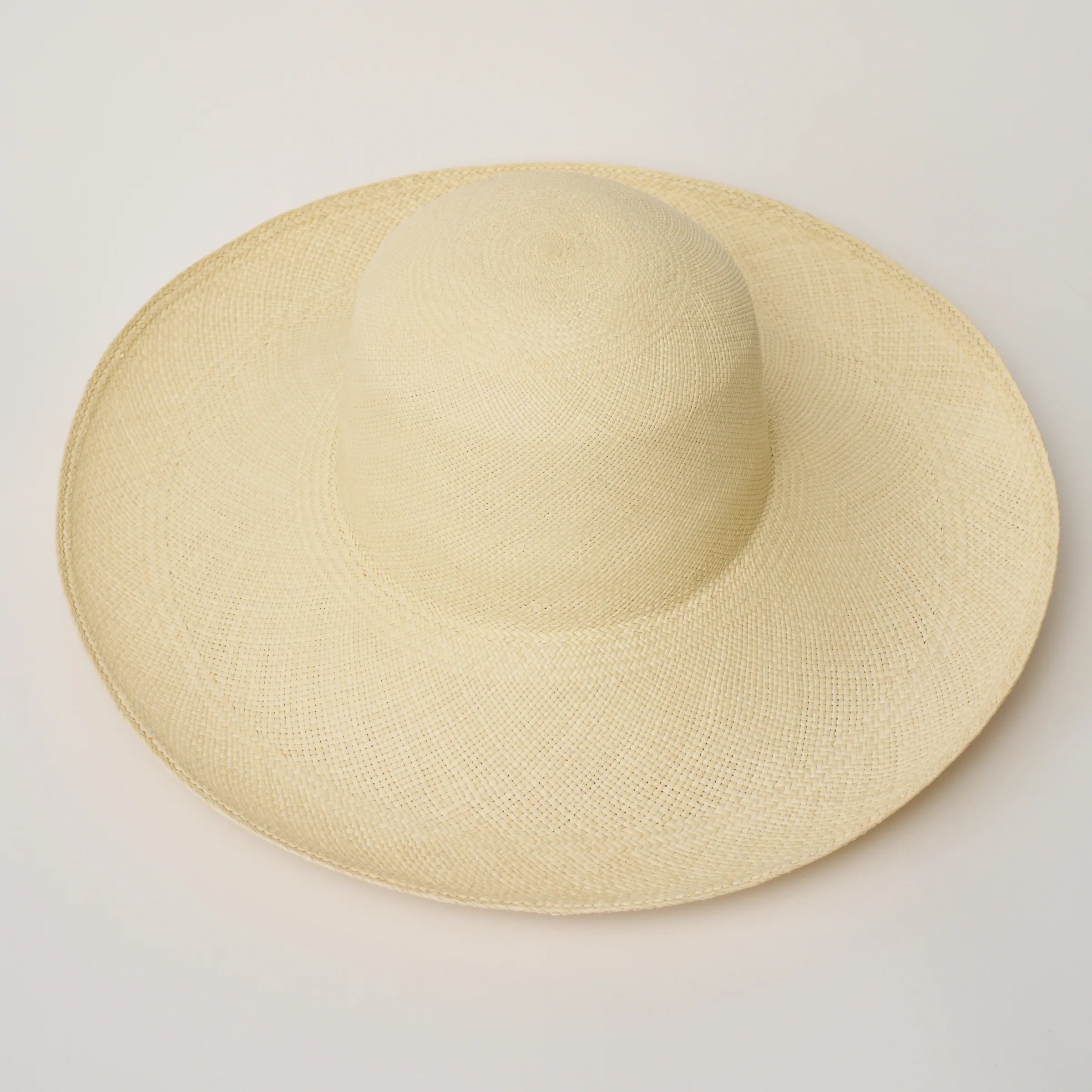Studio three-quarter view of the Alba Natural coloured Panama Hat, showing the crown shape and brim.