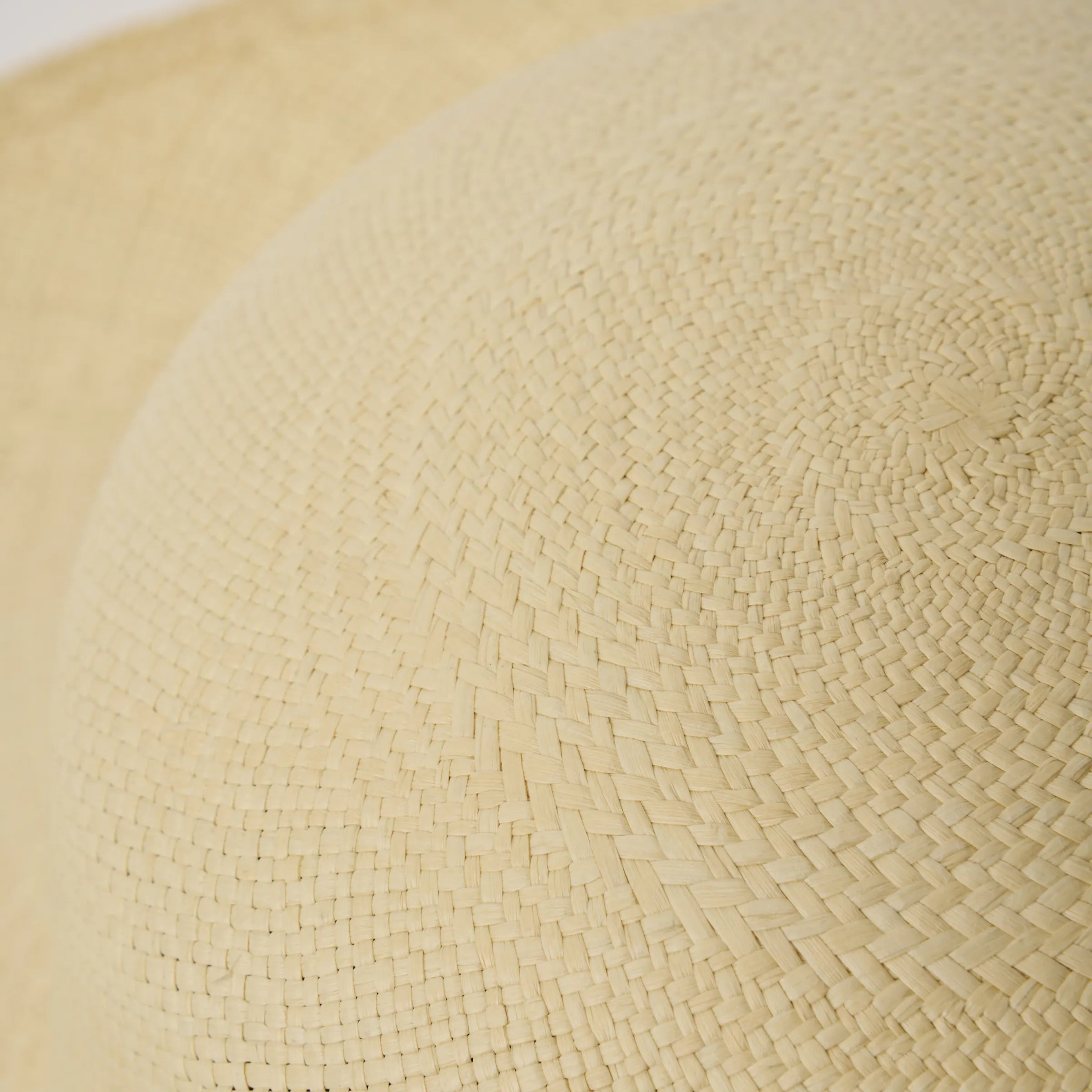 Close-up studio image of the Alba Natural coloured Panama Hat, showing the hand-woven toquilla straw texture.