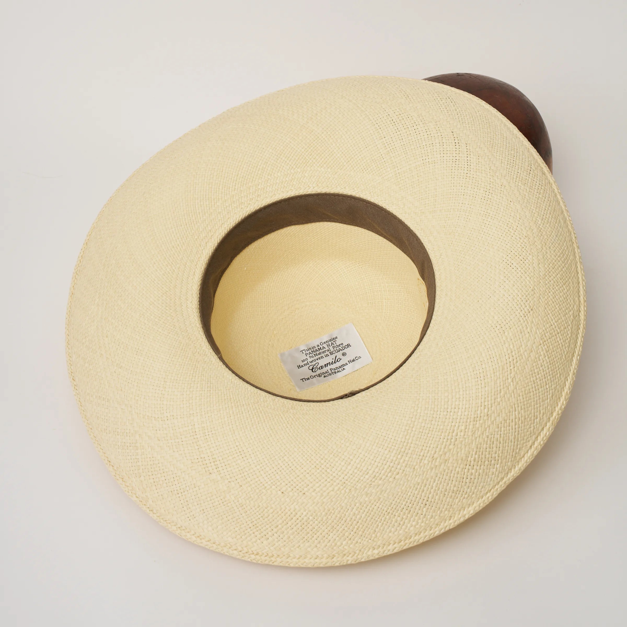 Studio image of the inside of the Alba Natural coloured Panama Hat, showing the sweatband and label.