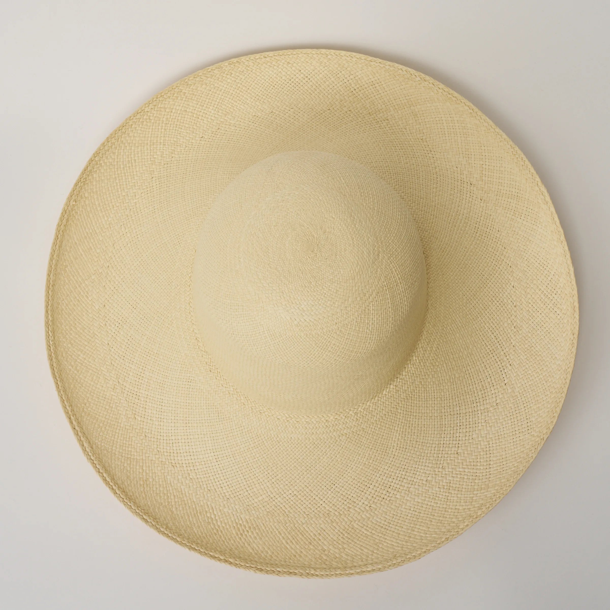 Top-down studio image of the Alba Natural coloured Panama Hat, showing the densely woven crown pattern.