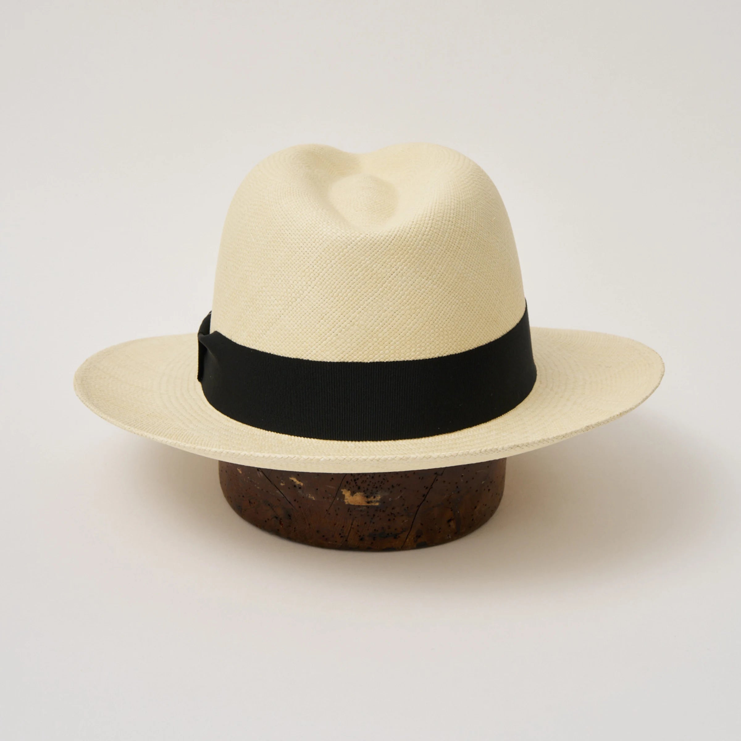 Studio image of the Camilo Classic Fino Natural coloured Panama Hat with Black trim taken from the back, showing snapback brim.