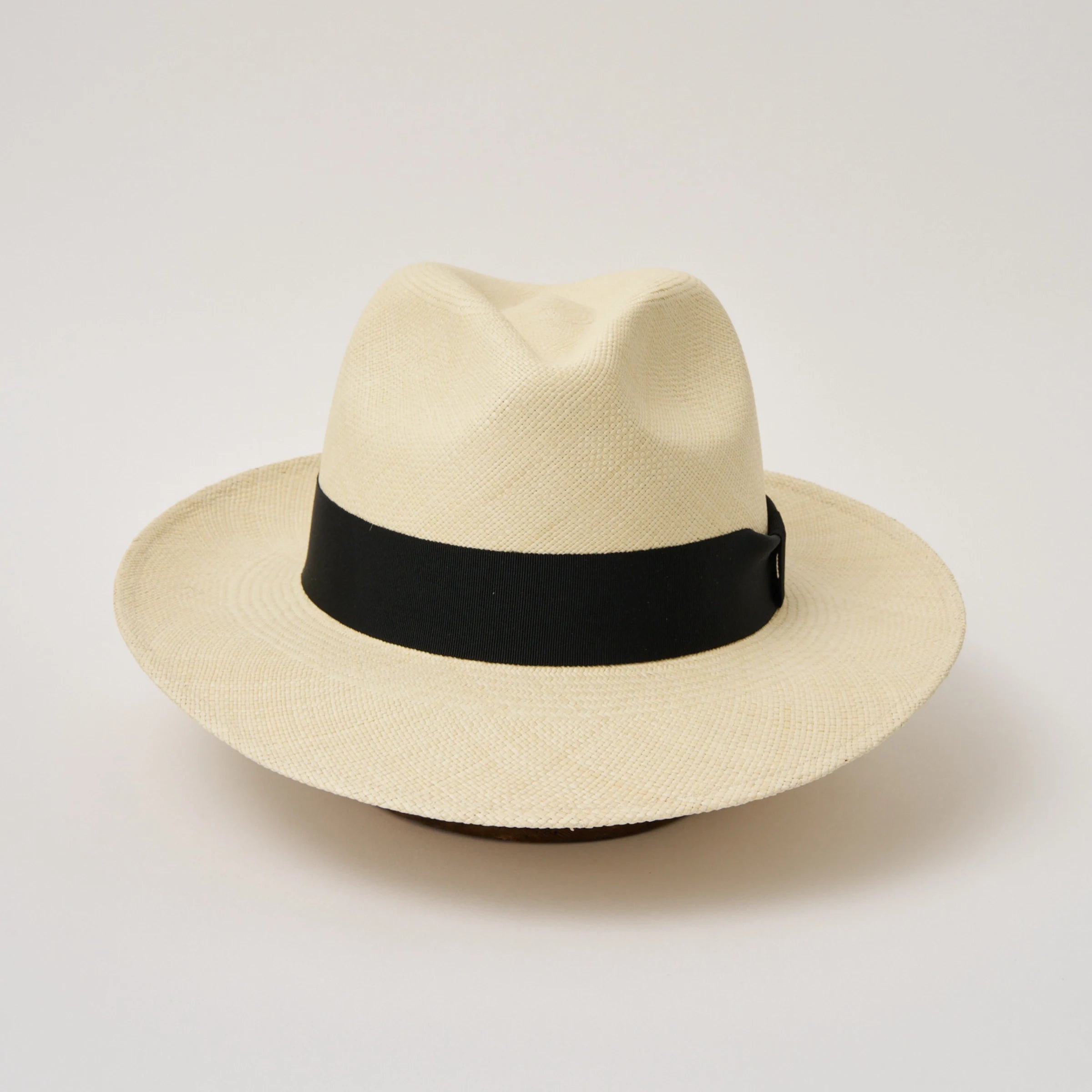 Studio image of the Camilo Classic Fino Natural coloured Panama Hat with Black trim taken from the front showing pinch.