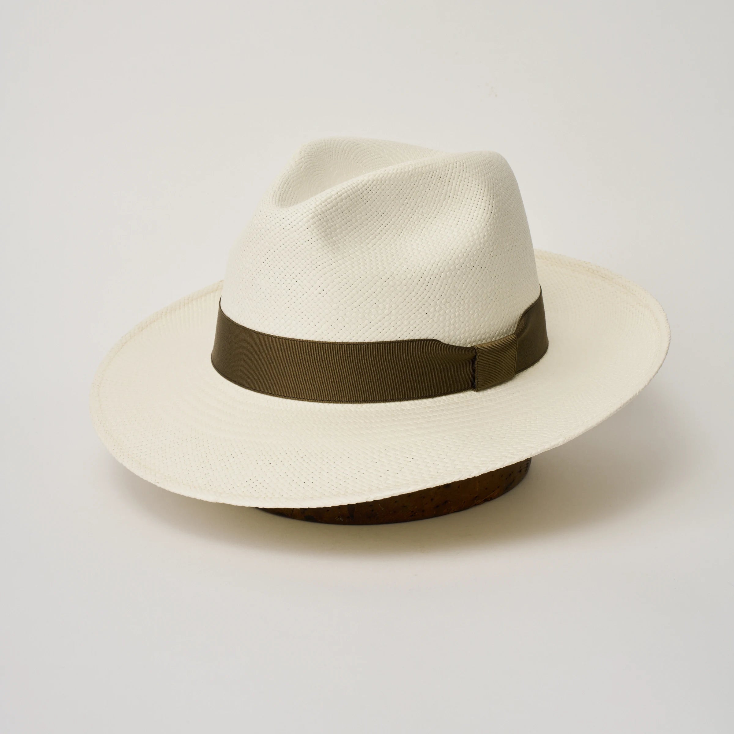 Studio image, three-quarter view of the Camilo Classic Cream coloured Panama Hat with Fawn trim, showing the crown shape, front crease and ribbon trim.