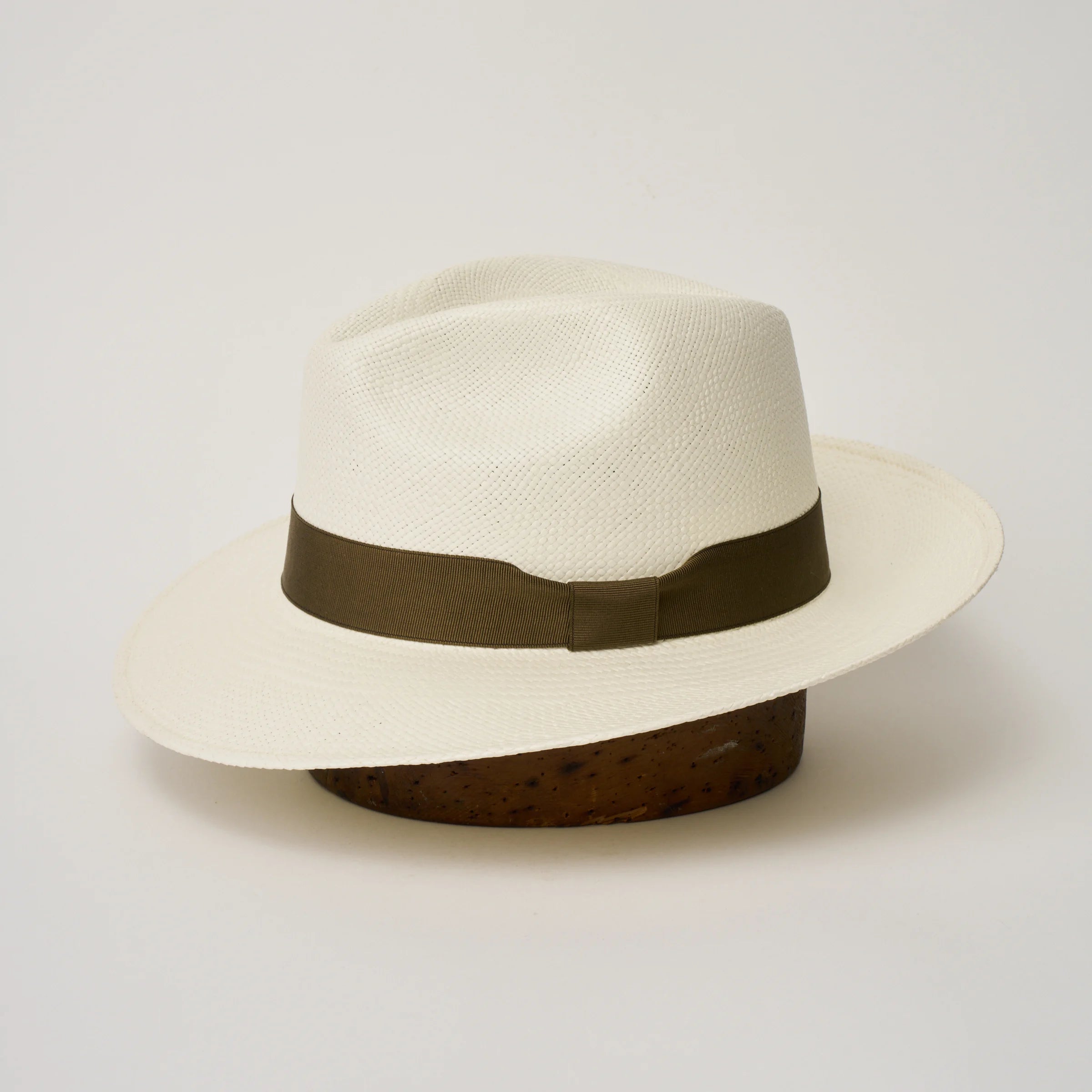 Studio image of the Camilo Classic Cream coloured Panama Hat with Fawn trim shown from the side, showing the brim shape and ribbon finish.