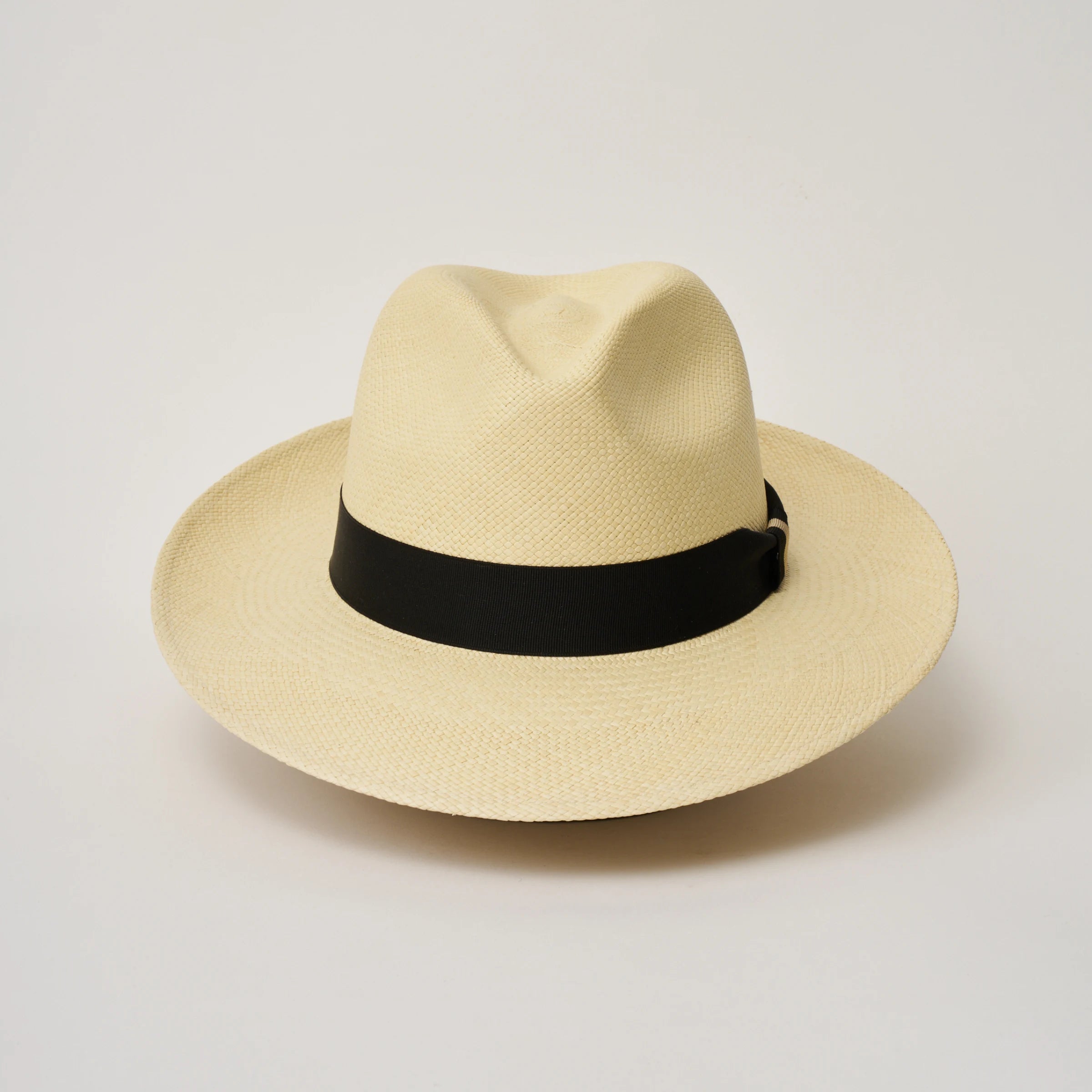 Studio image of the Camilo Classic Natural coloured Panama Hat with Black trim taken from the front, showing pinch.