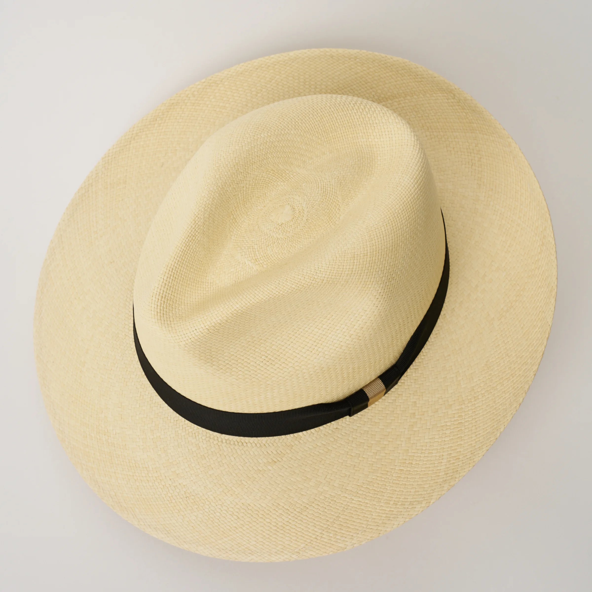 Studio image, looking top-down on the Camilo Classic Natural coloured Panama Hat with Black trim, showing the crown shape.