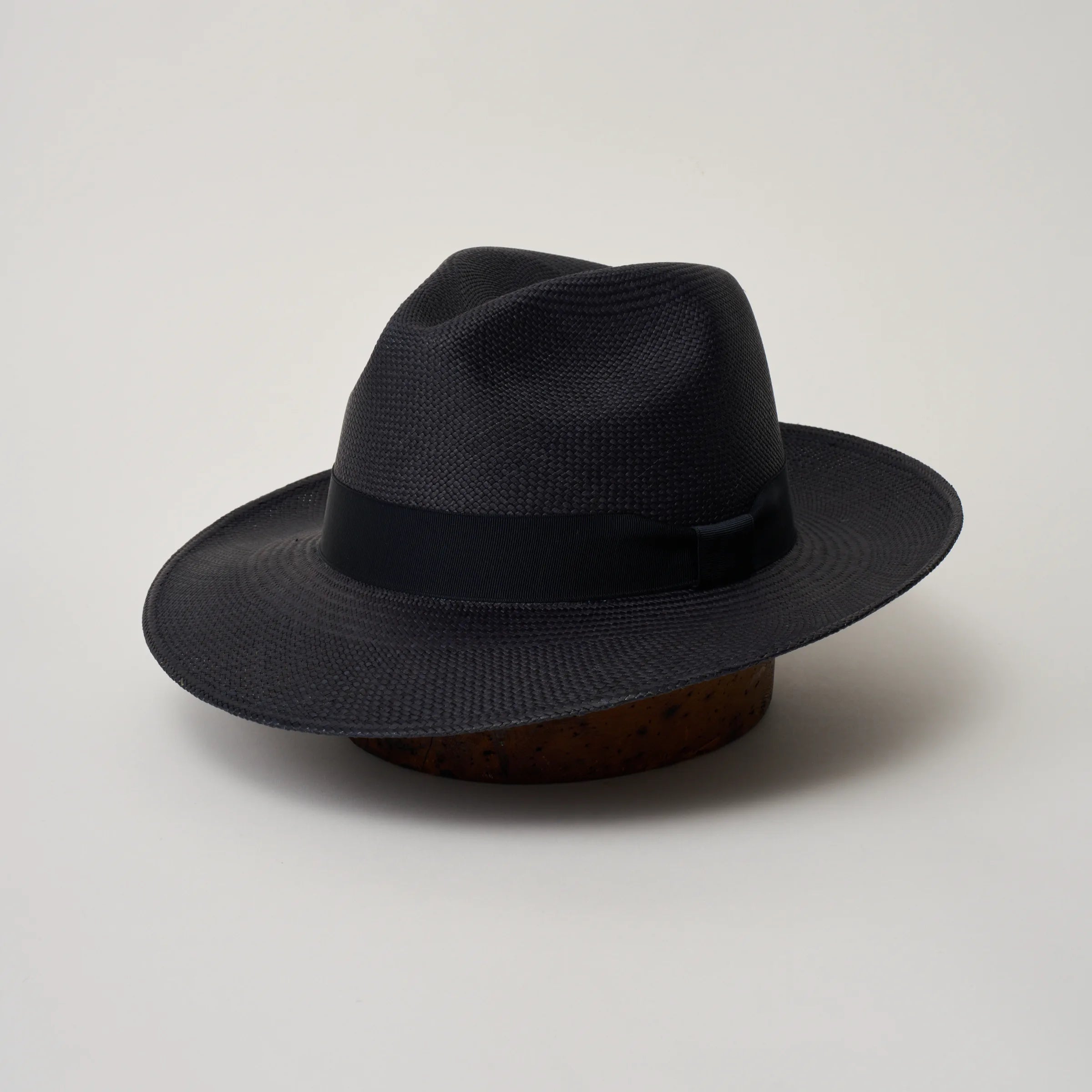 Studio image, showing anle view of the Camilo Classic Navy coloured Panama Hat with Marine trim, showing the crown crease and ribbon trim.